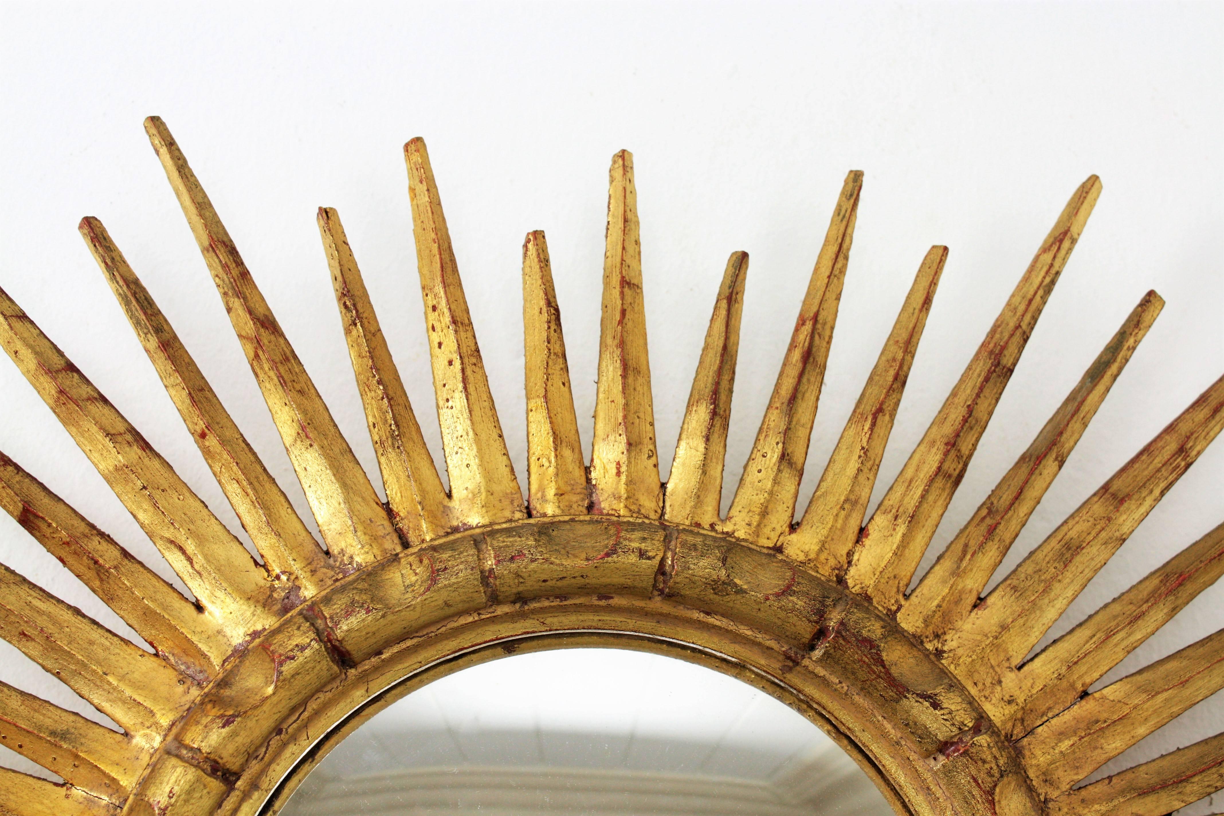 Hollywood Regency French 1940s Giltwood Convex Oval Sunburst Mirror with Gold Leaf Finish