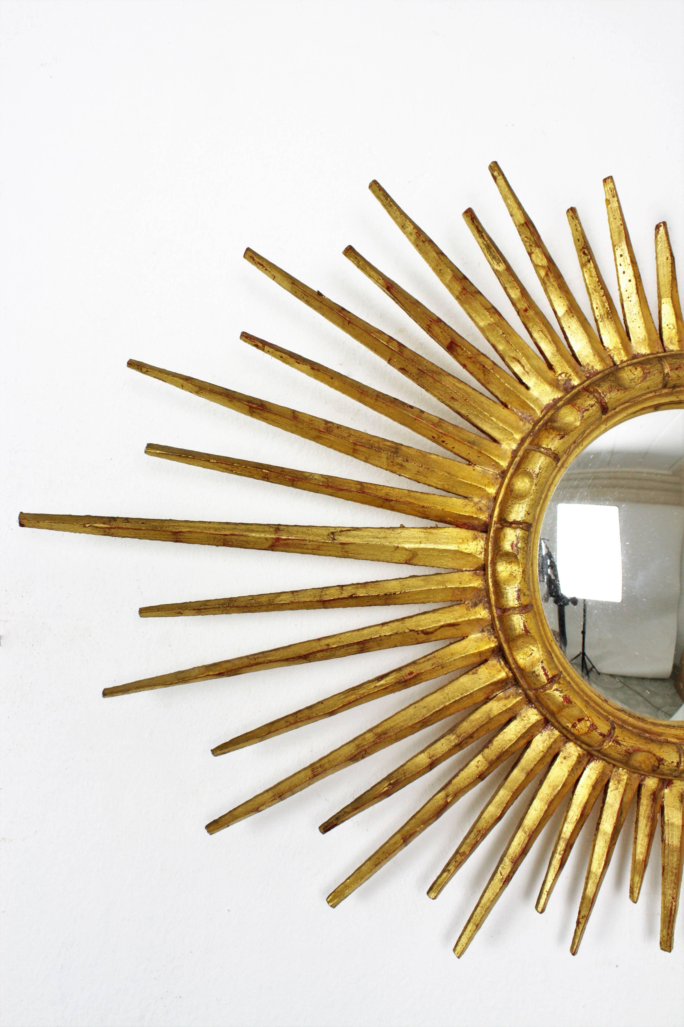 Carved French 1940s Giltwood Convex Oval Sunburst Mirror with Gold Leaf Finish