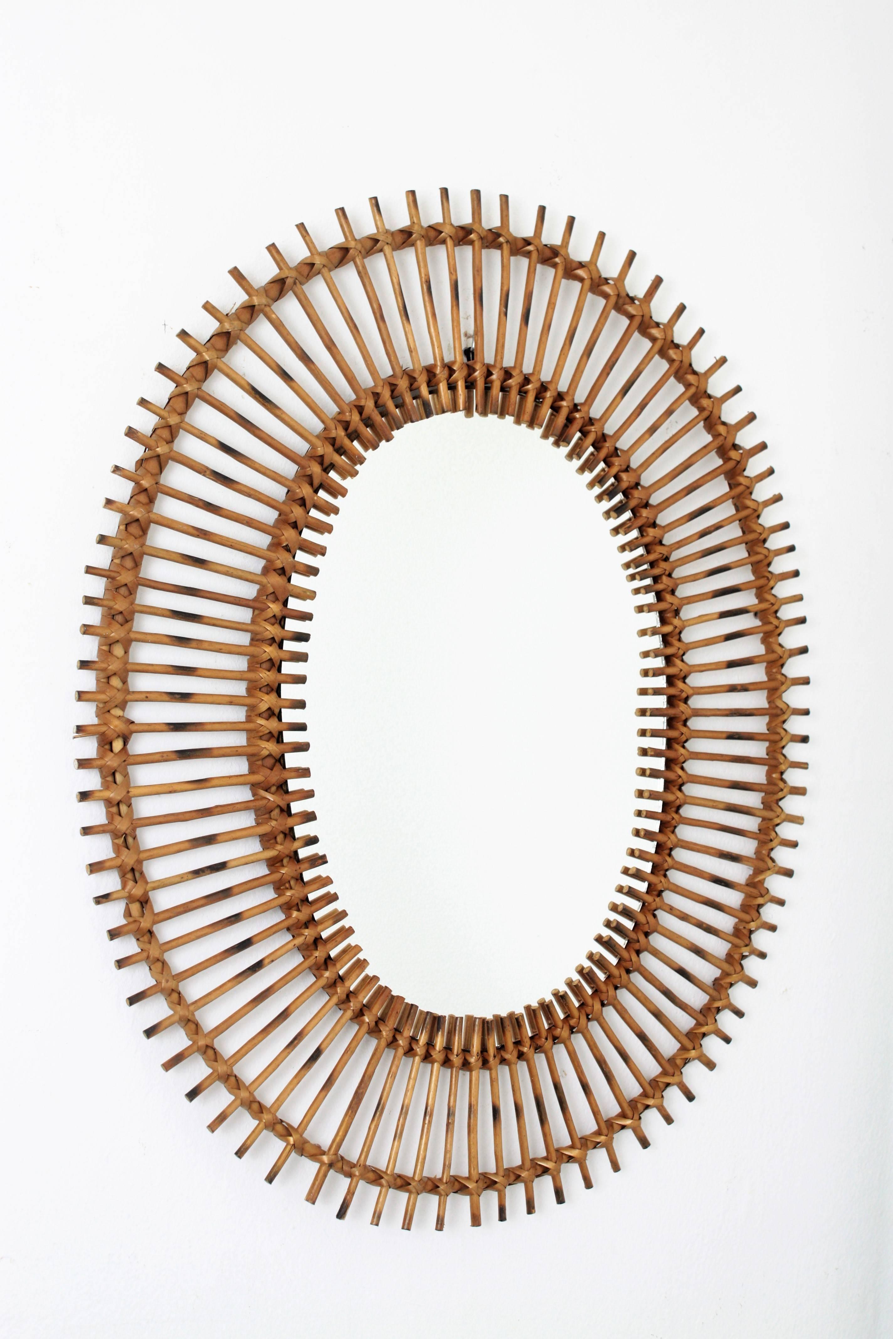 A beautiful handcrafted rattan or wicker sunburst mirror with oval shape, 
Spain, 1950s-1960s.


Avaliable a huge collection of mirrors in this manner. Please, kindly check our storefront. Join us as 1stdibs favourite dealer to receive our weekly