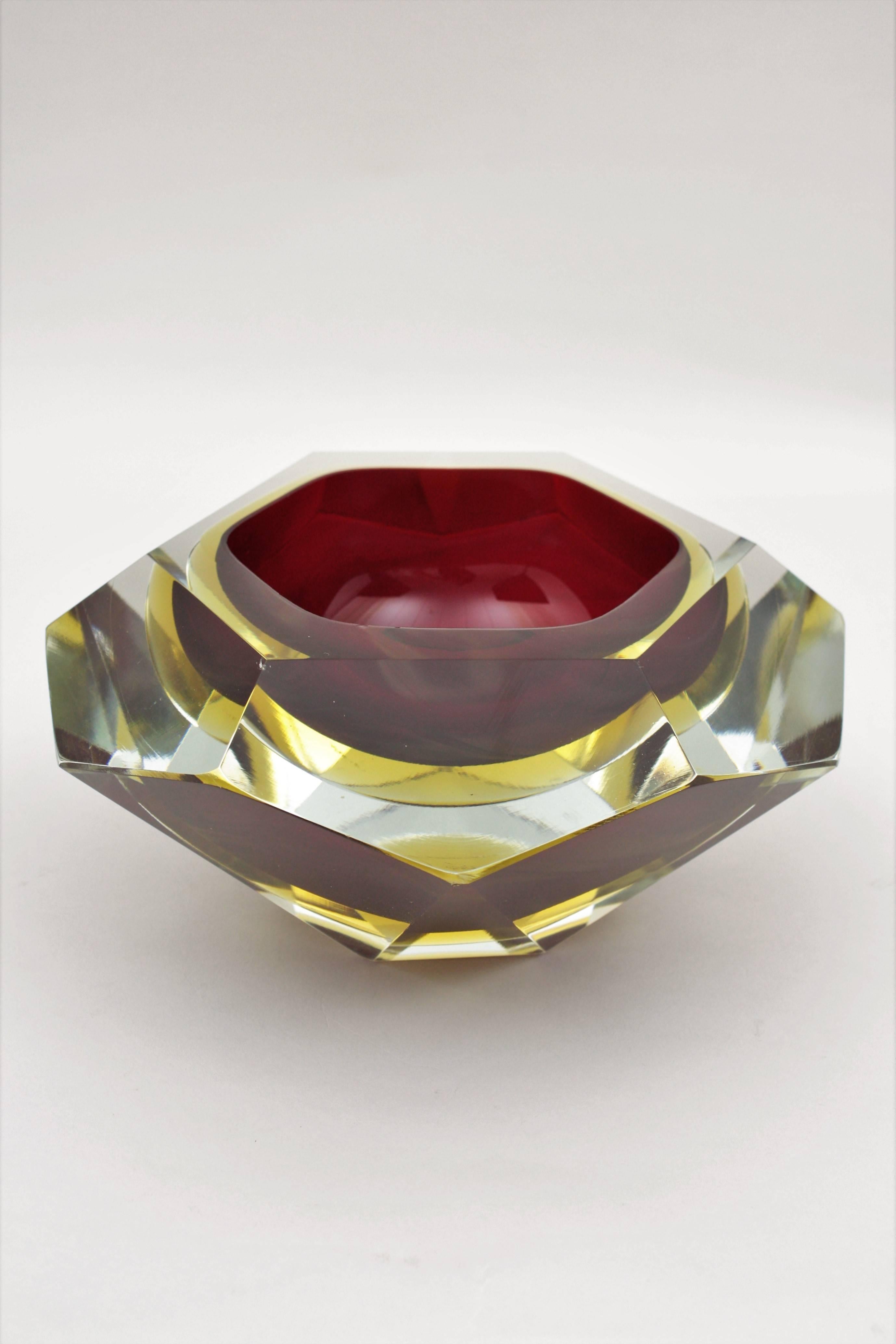A monumental and spectacular giant sized Sommerso faceted Murano glass bowl or centerpiece in ruby red and yellow double cased glass into clear class, faceted diamond shape and an unusual extra large size. The bigger size in this design we have ever