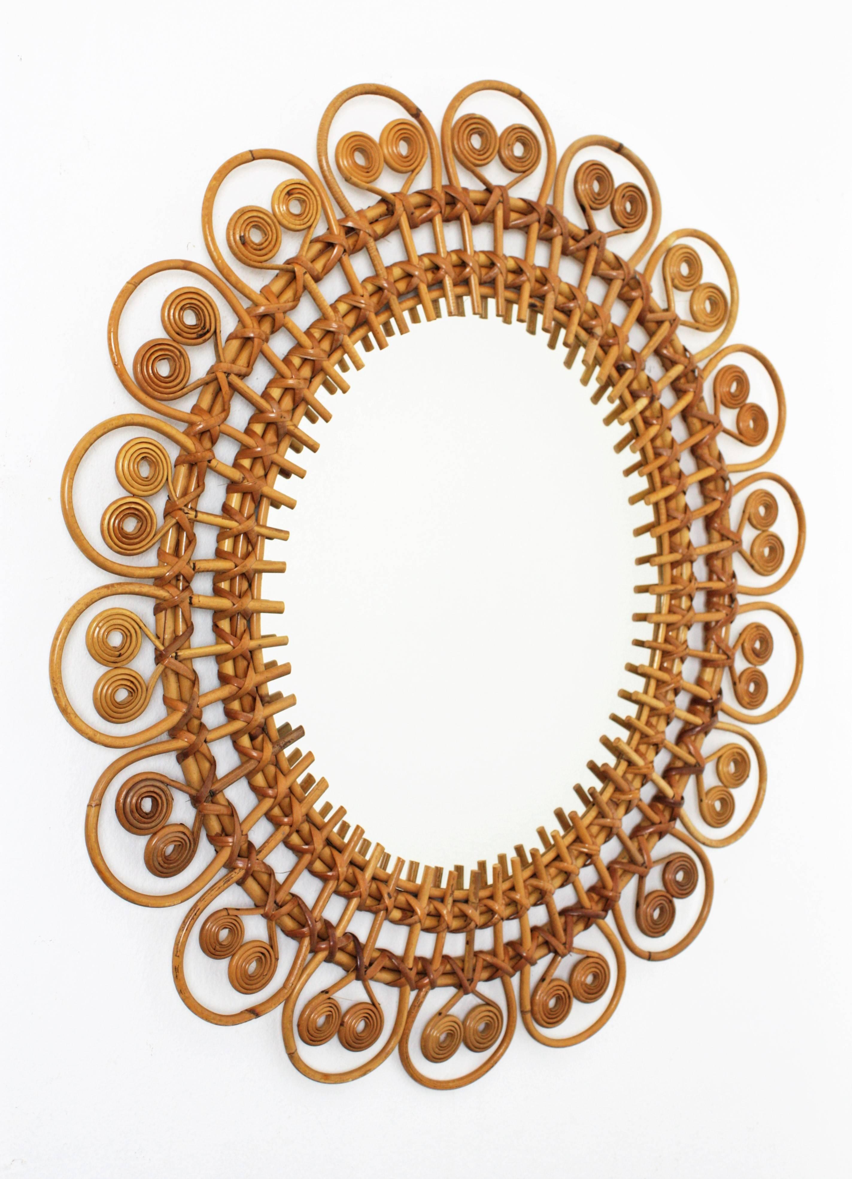 A highly decorative handcrafted rattan mirror with a frame combining a design with sun beams, flower petals and spit curls decoration. This piece was manufactured in France at the 1950s and it is in excellent vintage condition.
Dimensions of the