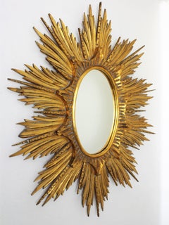 Large 1940s Carved Giltwood Hollywood Regency Sunburst or Starburst Oval Mirror