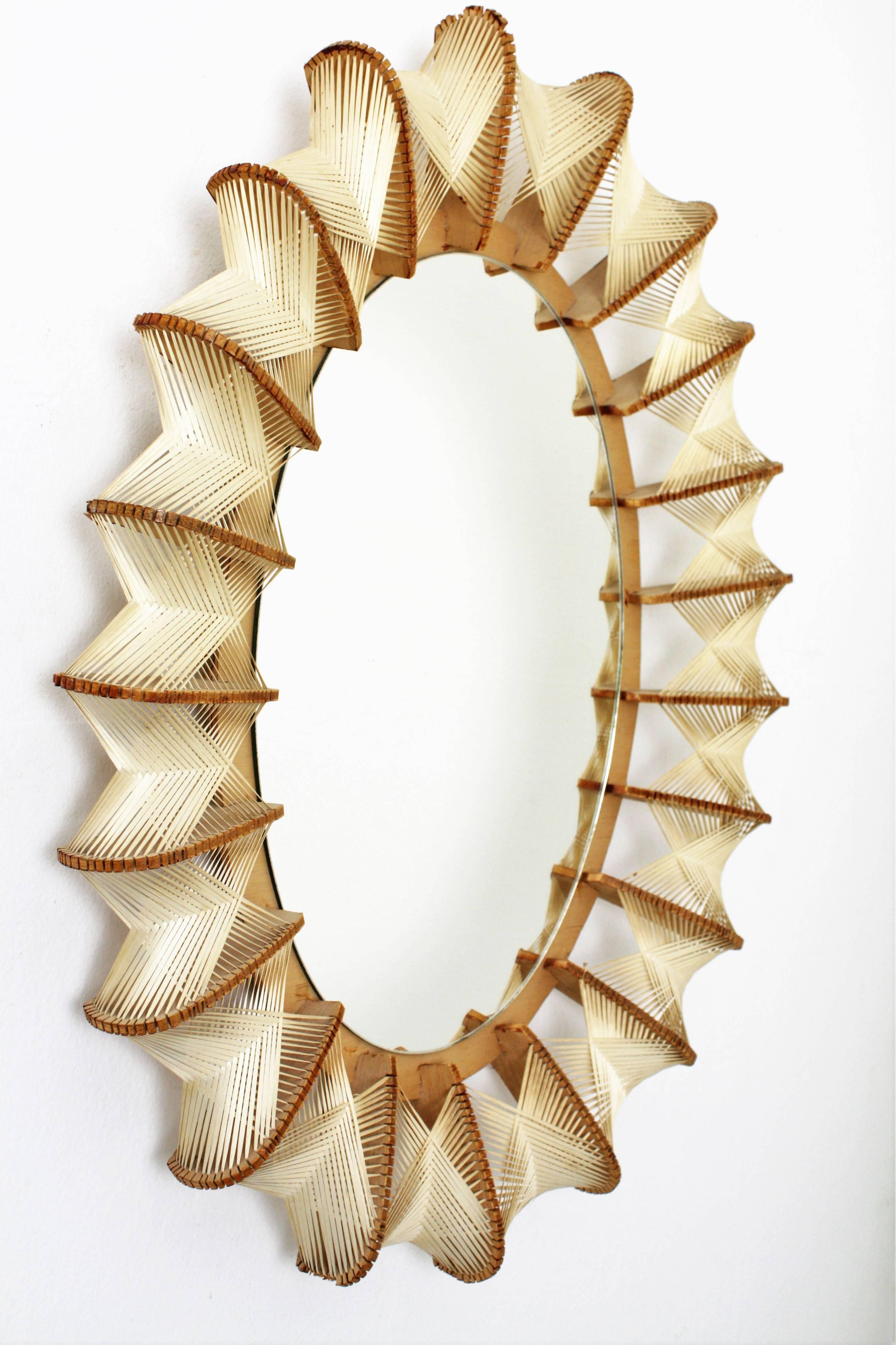Mid-Century Modern oval mirror made with wood and hand woven wicker frame decoration that create a beautiful geometric design with Nordic style accents.
France, 1960s.

Avaliable a huge collection of rattan, bamboo and wicker mirrors. Please kindly