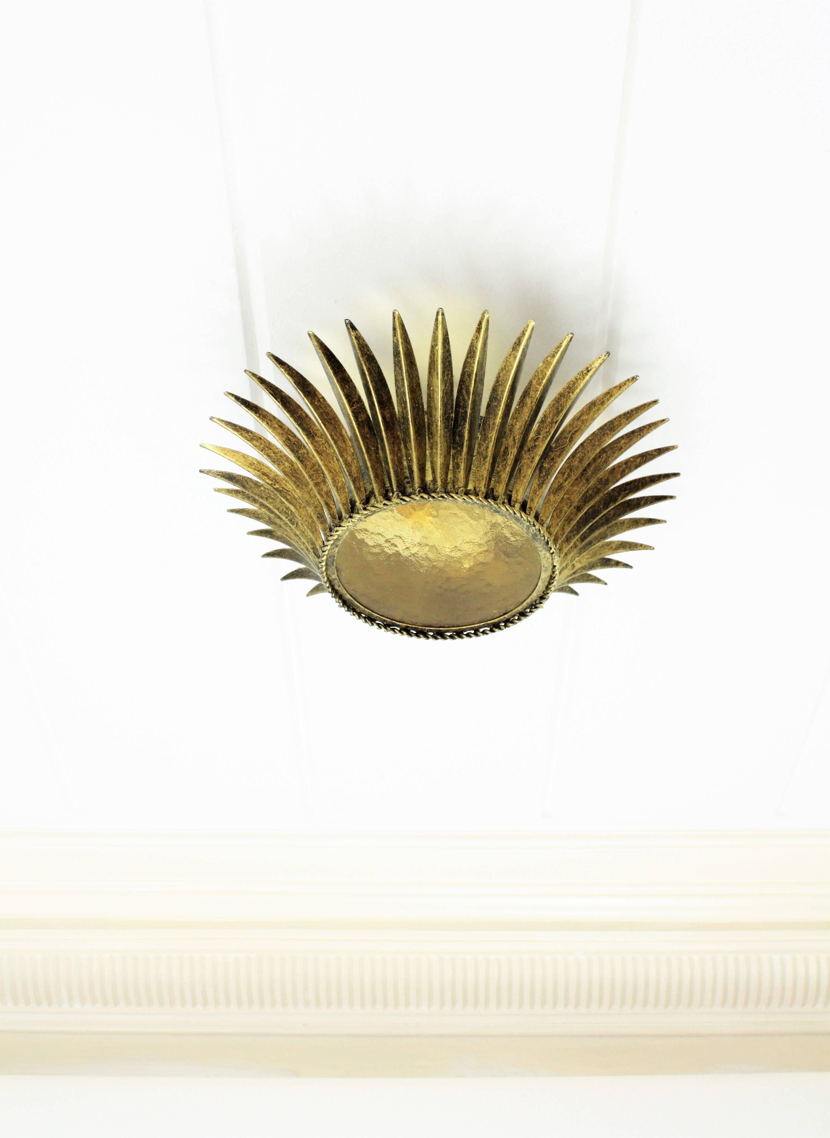 An elegant crown shape sunburst light fixture or flush mount made in gilt ron with amber glass. It has one bulb. The glass shade diameter is 16.5 cm
Spain, 1950s. The glass can be changed by a frosted glass by request.

Follow  us as 1stDibs