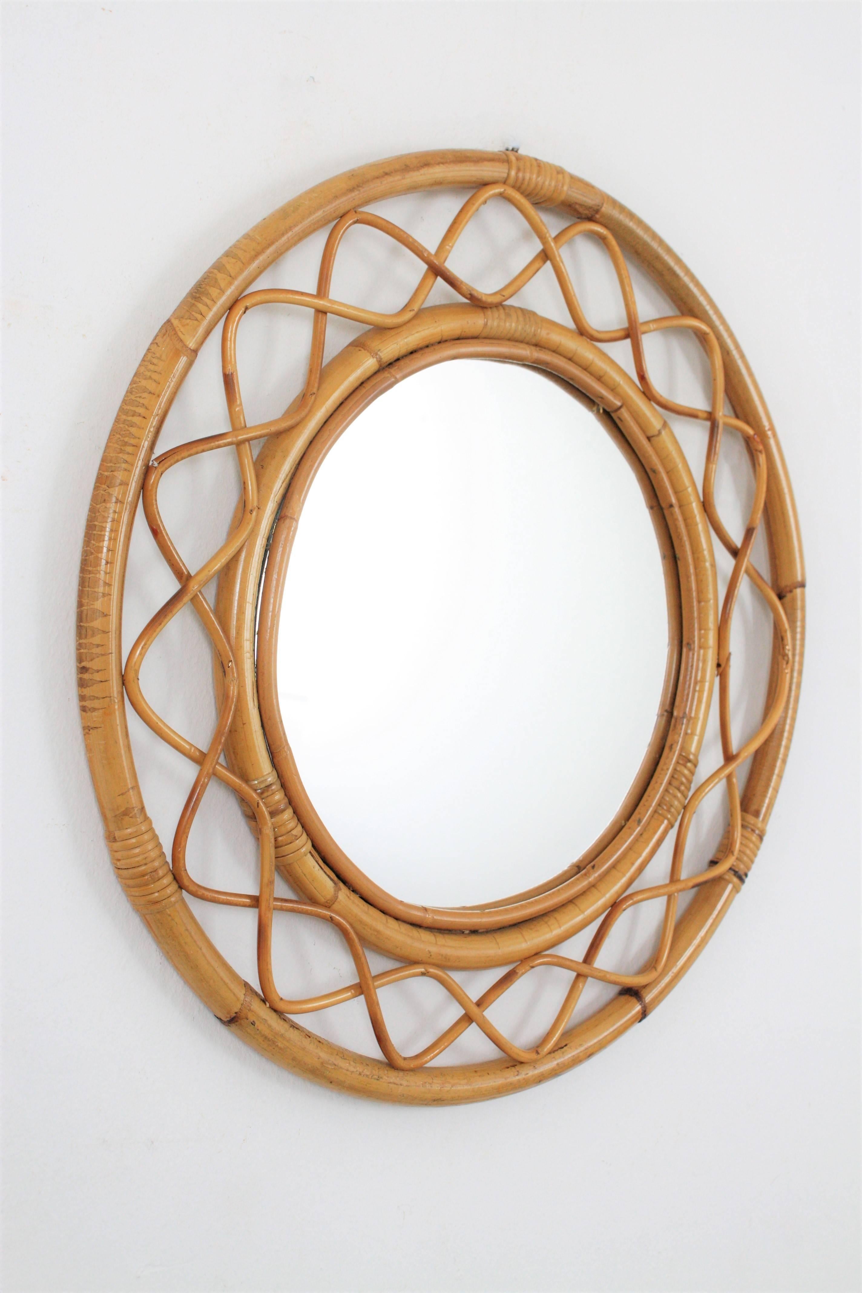 Beautiful handcrafted bamboo and rattan circular mirror with all the taste of the Mediterranean coast style. In the style of Jean Royère,
France, 1960s.
Lovely to place it alone and also beautiful creating a wall decoration with other mirrors in