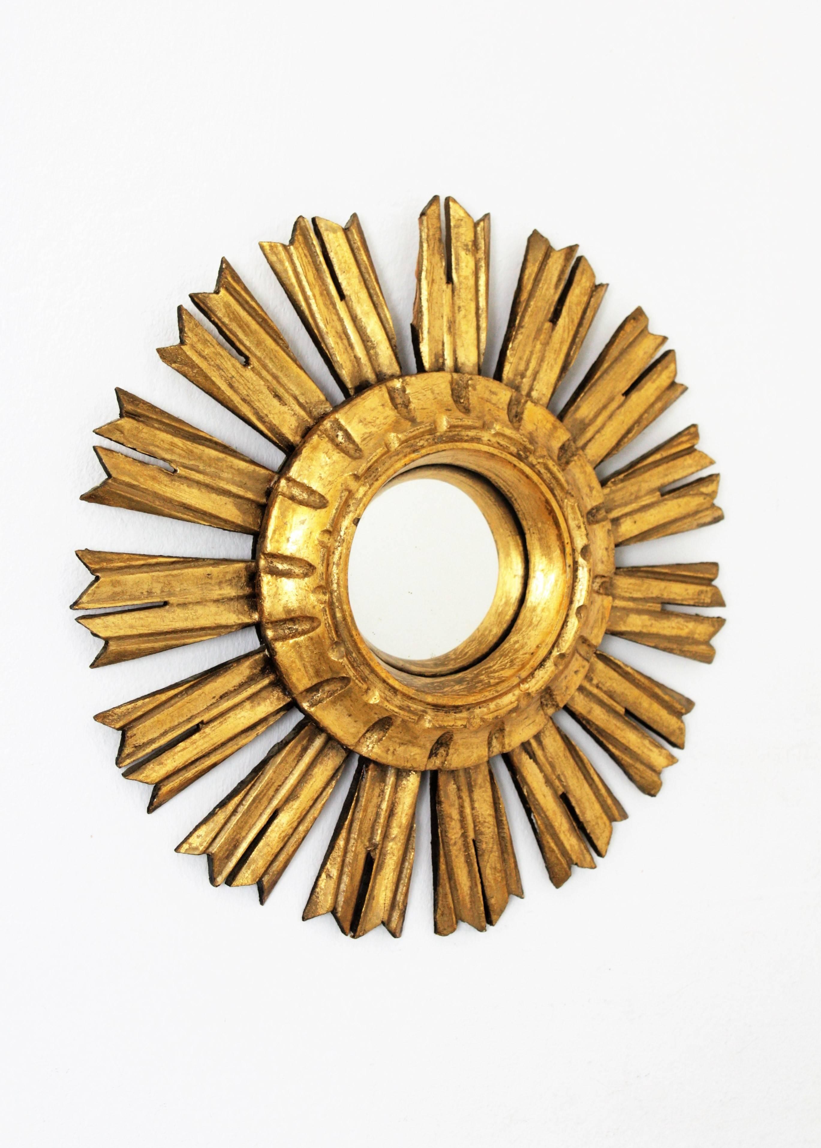 Lovely mini sized Baroque style giltwood sunburst mirror with convex glass. This small mirror is perfect to place alone, but its unusual size makes the piece highly decorative to place it with sunburst mirrors in other sizes creating a wall