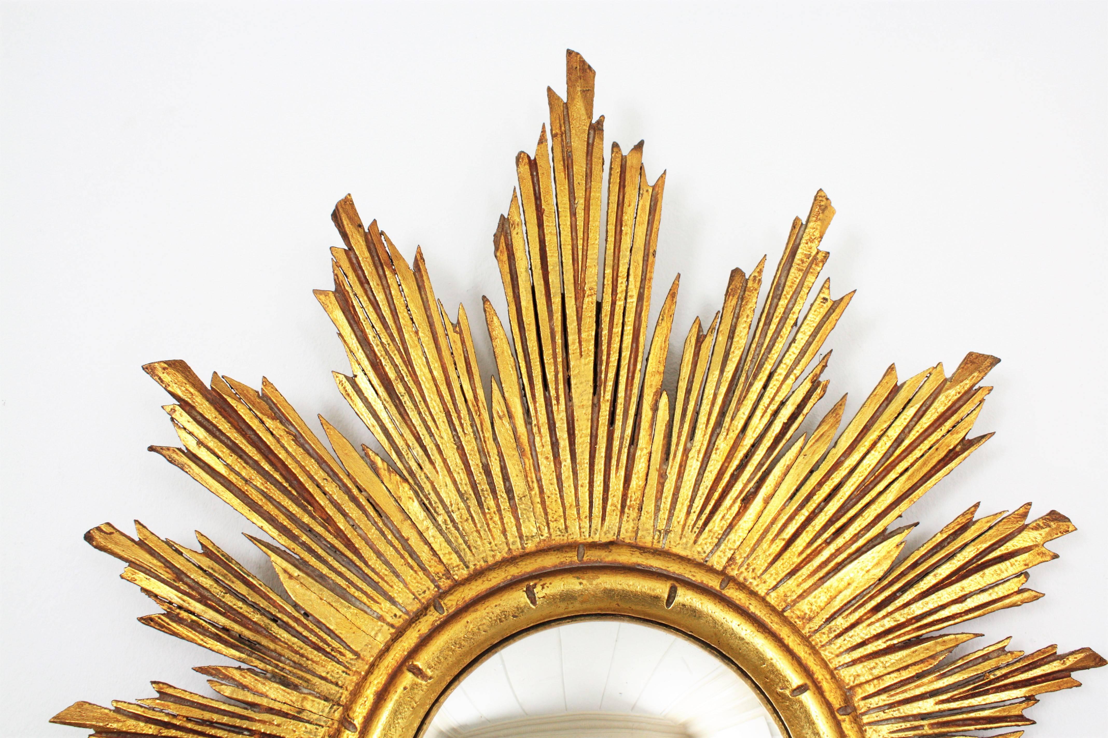 Spanish Hollywood Regency Carved Giltwood Oval Sunburst Convex Mirror, Spain 1940s