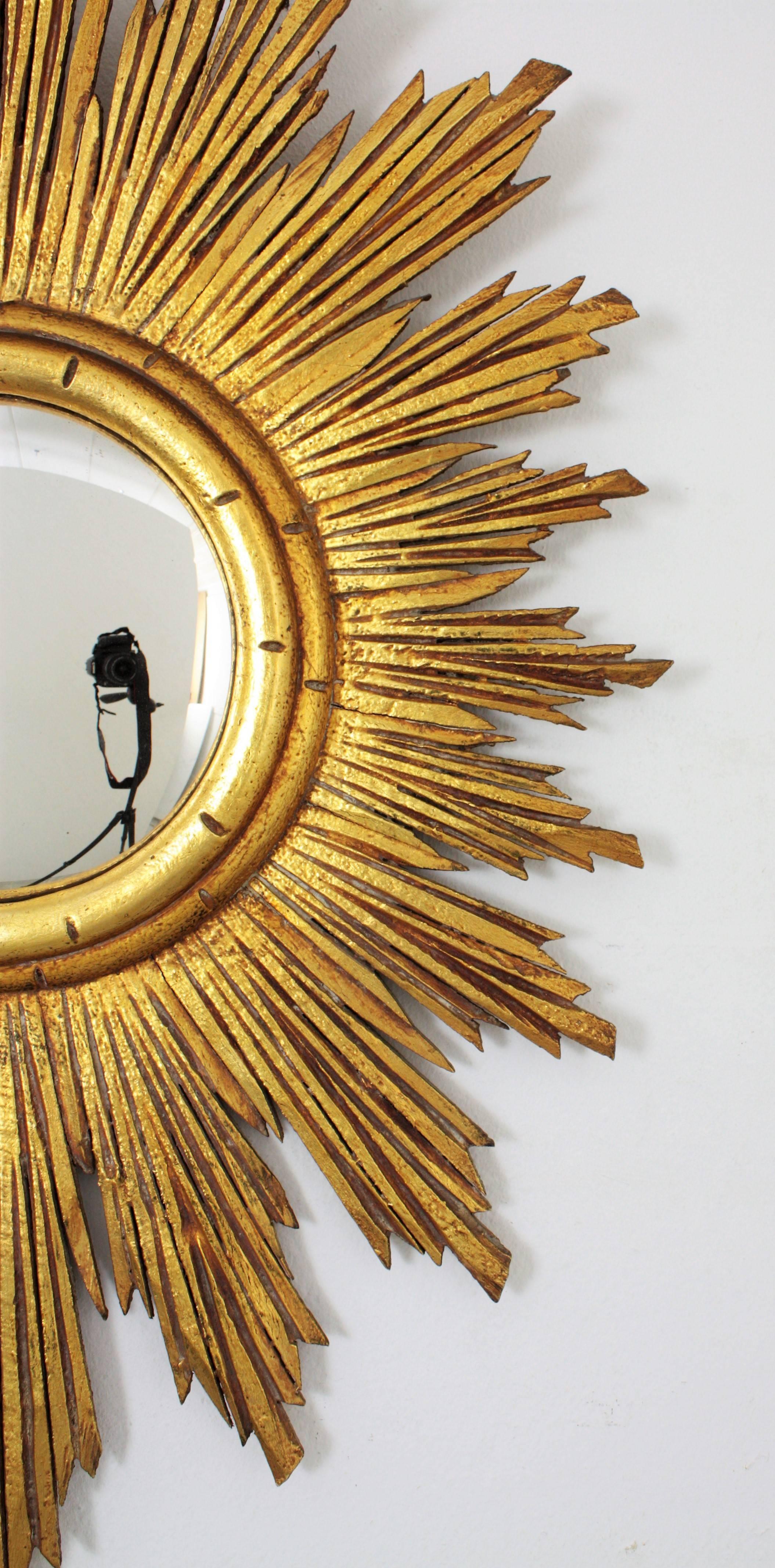 Wood Hollywood Regency Carved Giltwood Oval Sunburst Convex Mirror, Spain 1940s