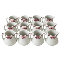 Collection of 12 Shenango China Creamers in the Chardon Rose Red Pattern
