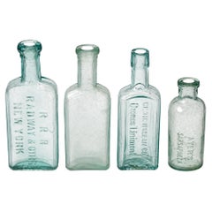 Set of Four Antique American Medicine Bottles in Aqua Glass