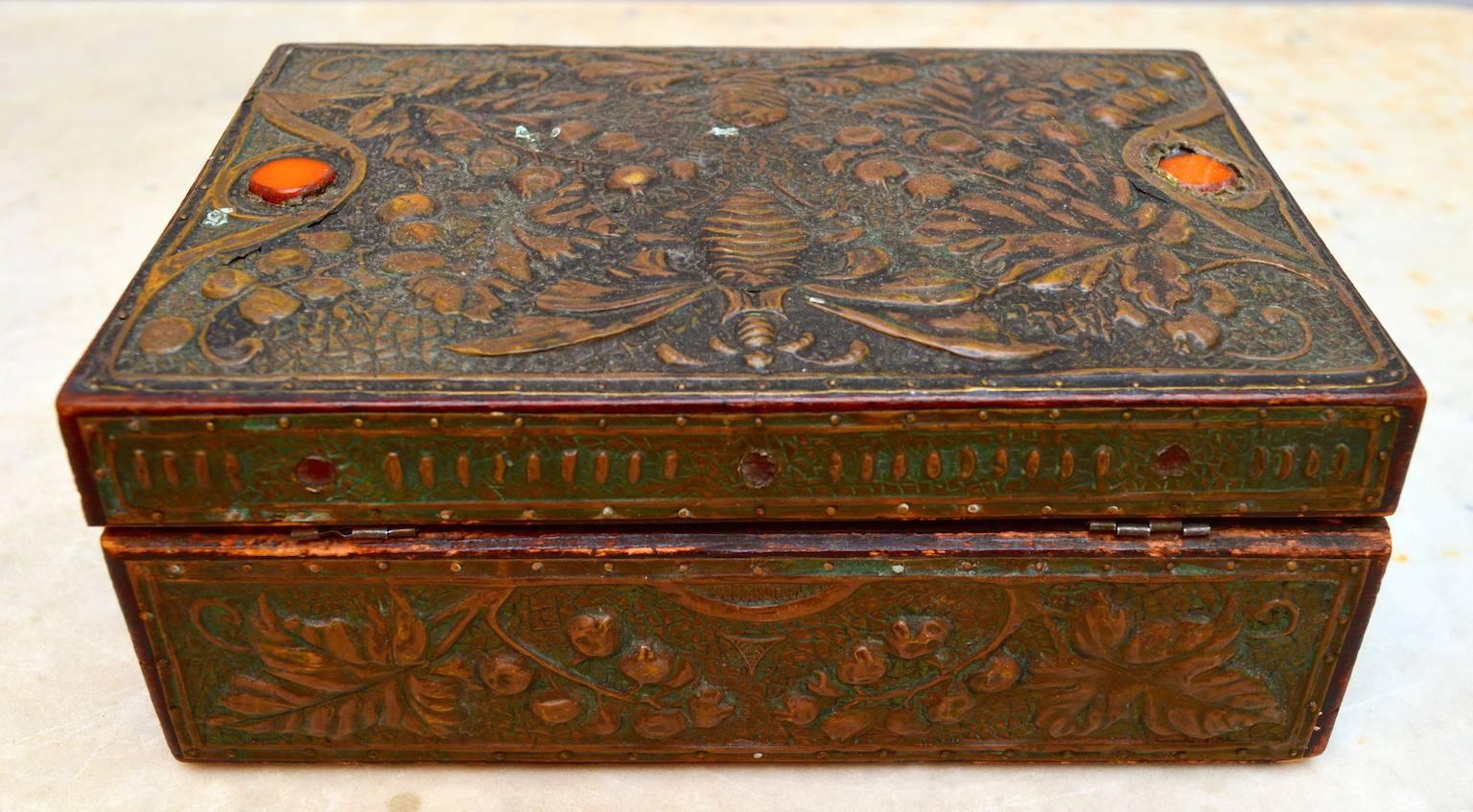 A beautiful example of the workmanship of Art Nouveau accessories; this wood box is covered in hand embossed copper sheeting and set with glass stones.
Made by a Belgian craftsman in the period of the birth of Belgium's monarchy.