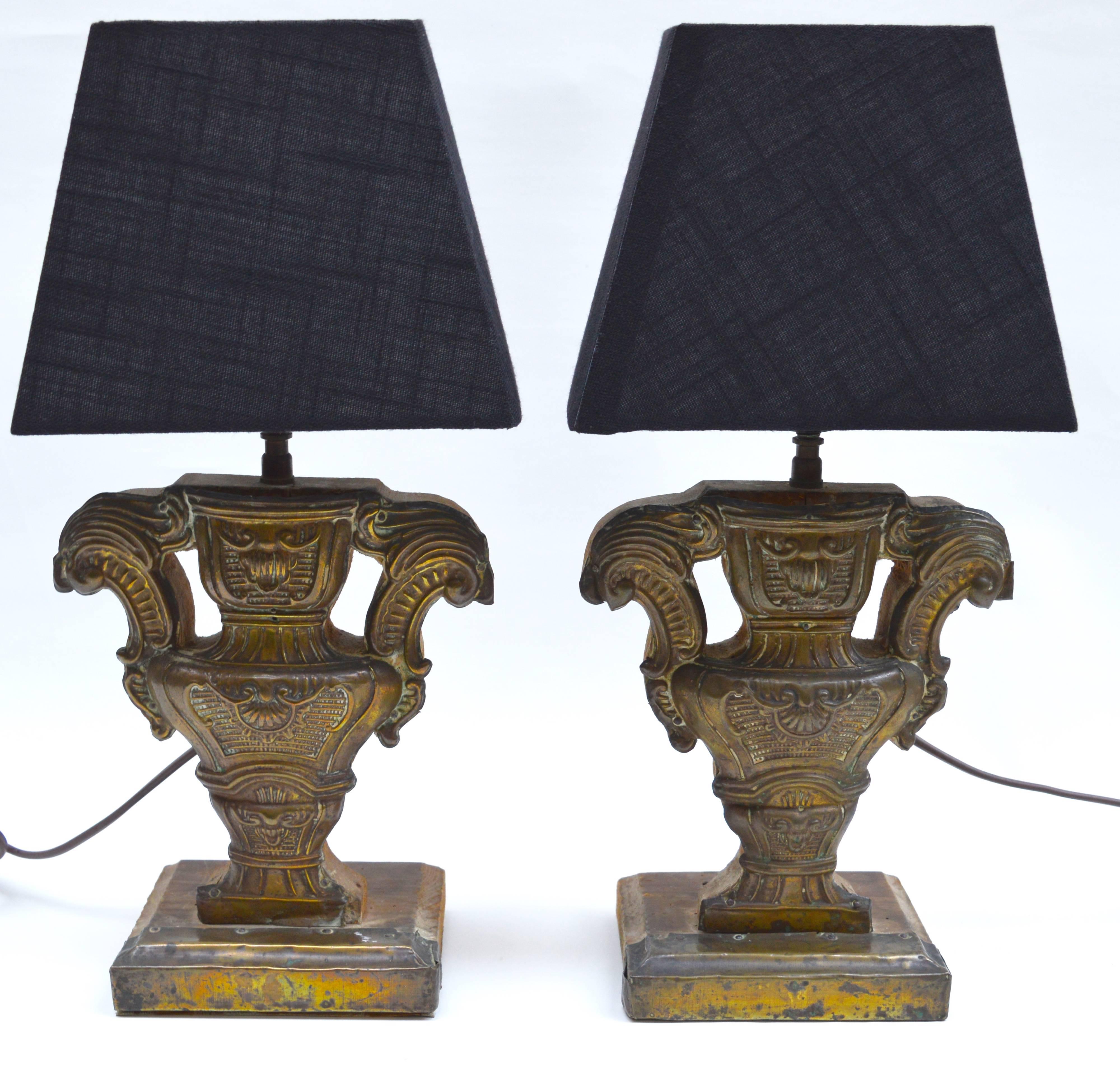 A pair of Italian 18th century altar candlesticks transformed into table lamps.
The base is pine wood covered in beautifully hand worked repousse brass. Great patina that can only acquired from time and use.
**Including black shades.
 