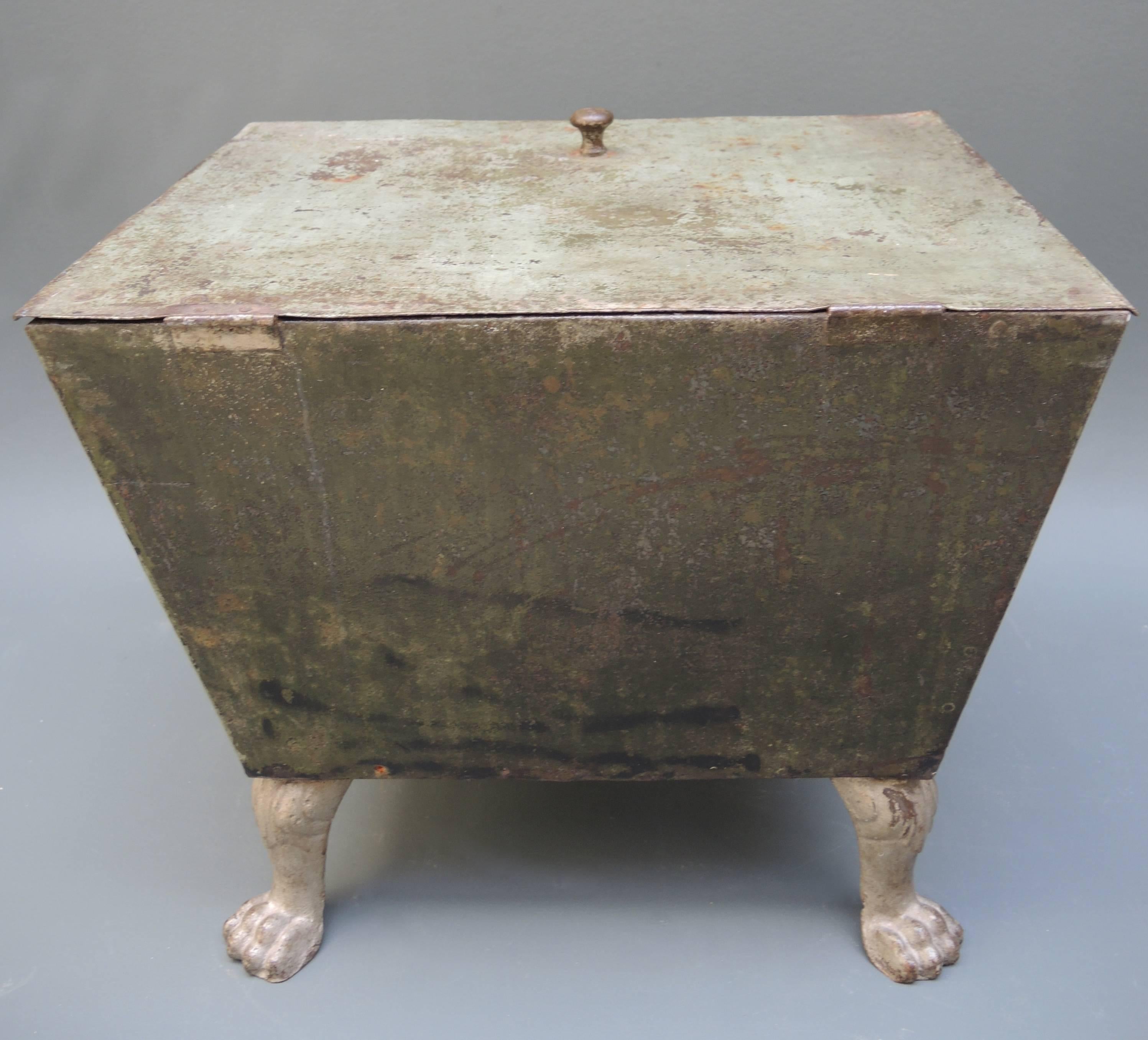 Mid-19th century French iron box with four lion paw feet. Fantastic original mint green and olive paint.
Originally used for firewood or coal, but is also the perfect height to use as a small coffee table.