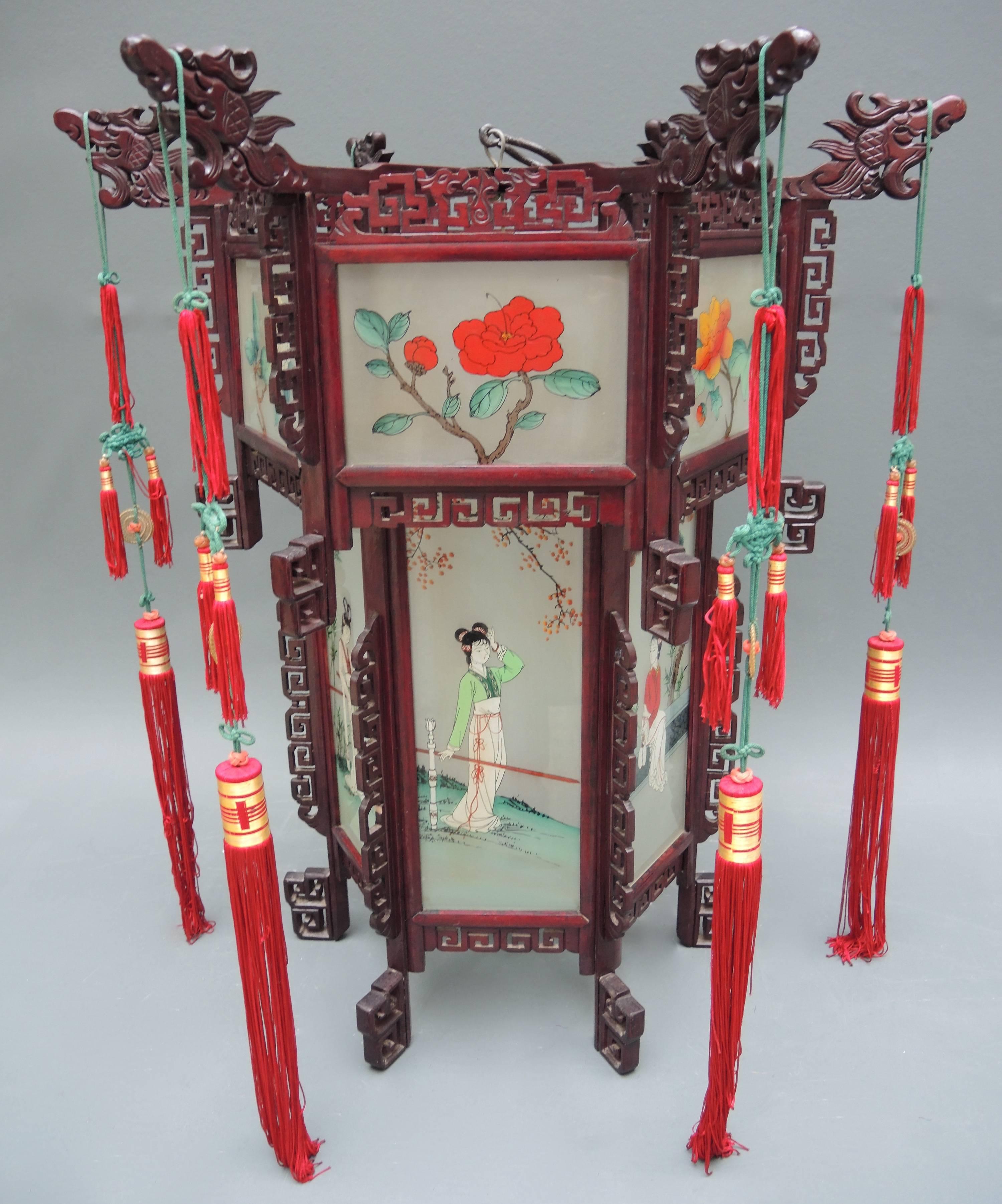 This large Chinese lantern retains all the original glass panels that have been reverse painted by hand on the glass. No breaks or missing pieces truly a rare finds!
The lantern was made in the 1940s and includes the red and green knotted tassels