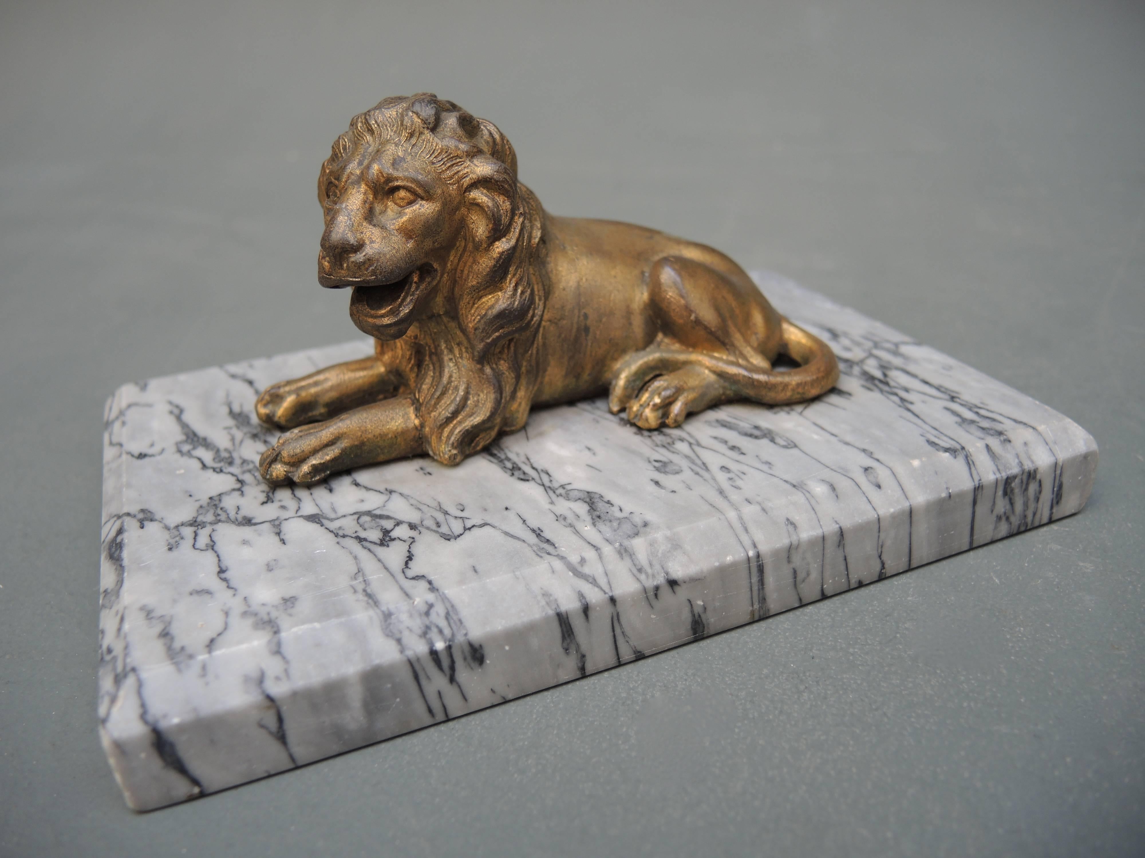An elegant statue of a lion mounted on a marble base to be used as a desk accessory paper weigh. A perfect gift!