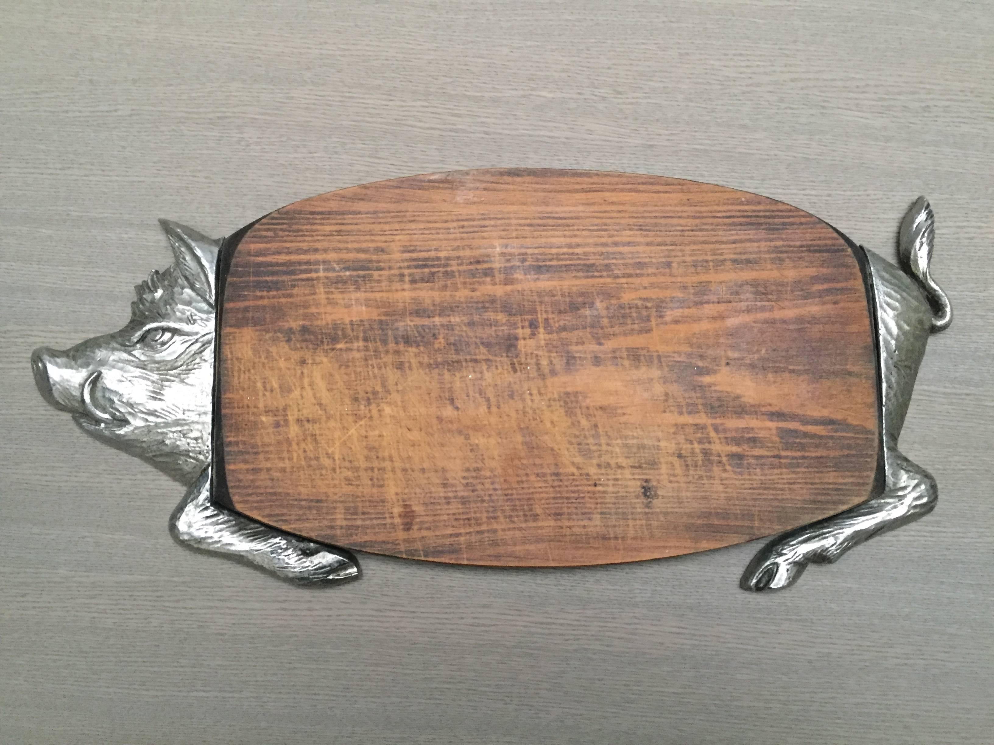 A vintage French charcuterie serving board in the form of a wild boar. Charcuterie consist primarily of pork products such as sausage, terrines, galantines, ballotines, pâtés, and confit. The French eat charcuterie with crusty bread daily as a late