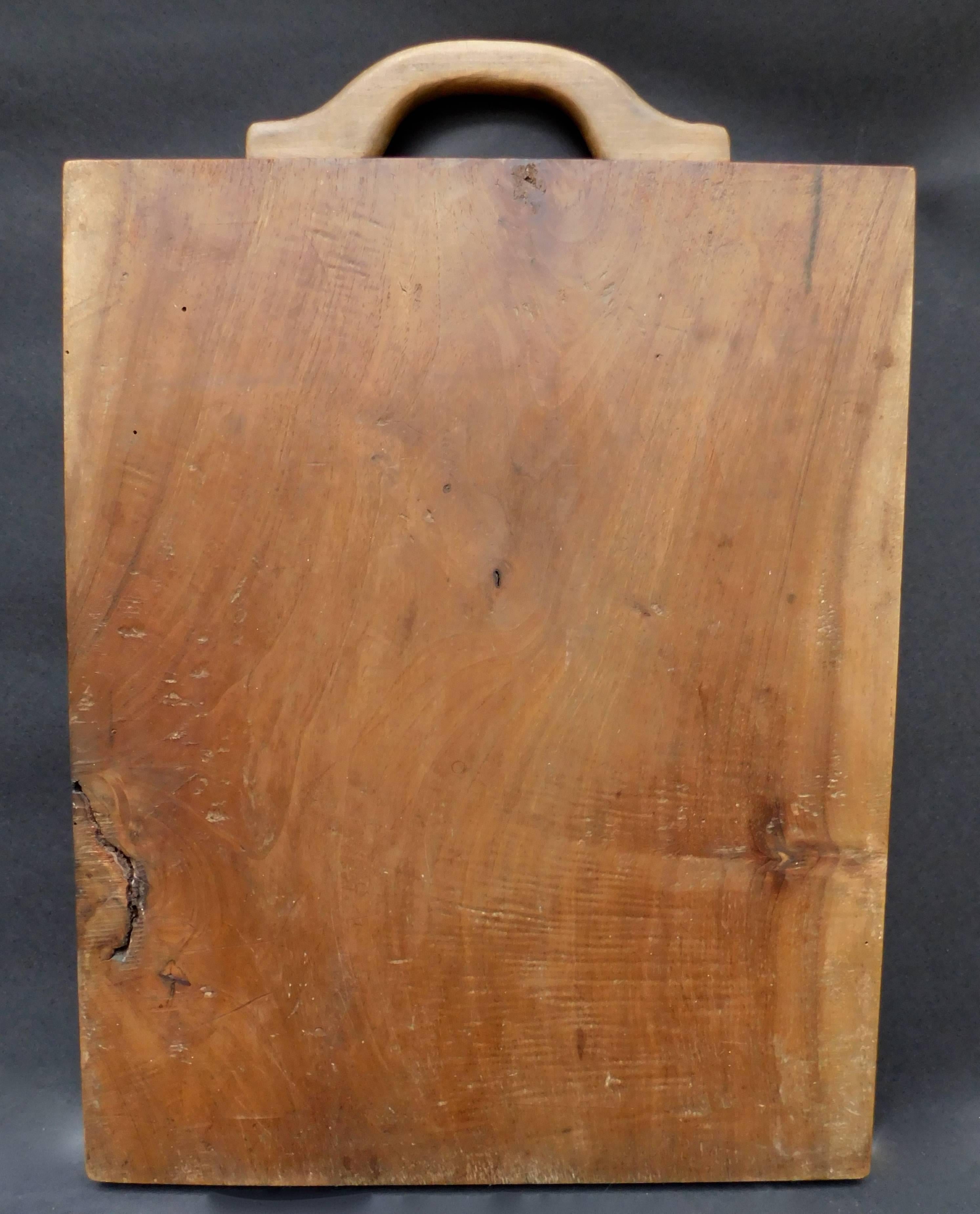 A vintage French cutting board made from one solid plank of wild cherry wood.Circa 1940