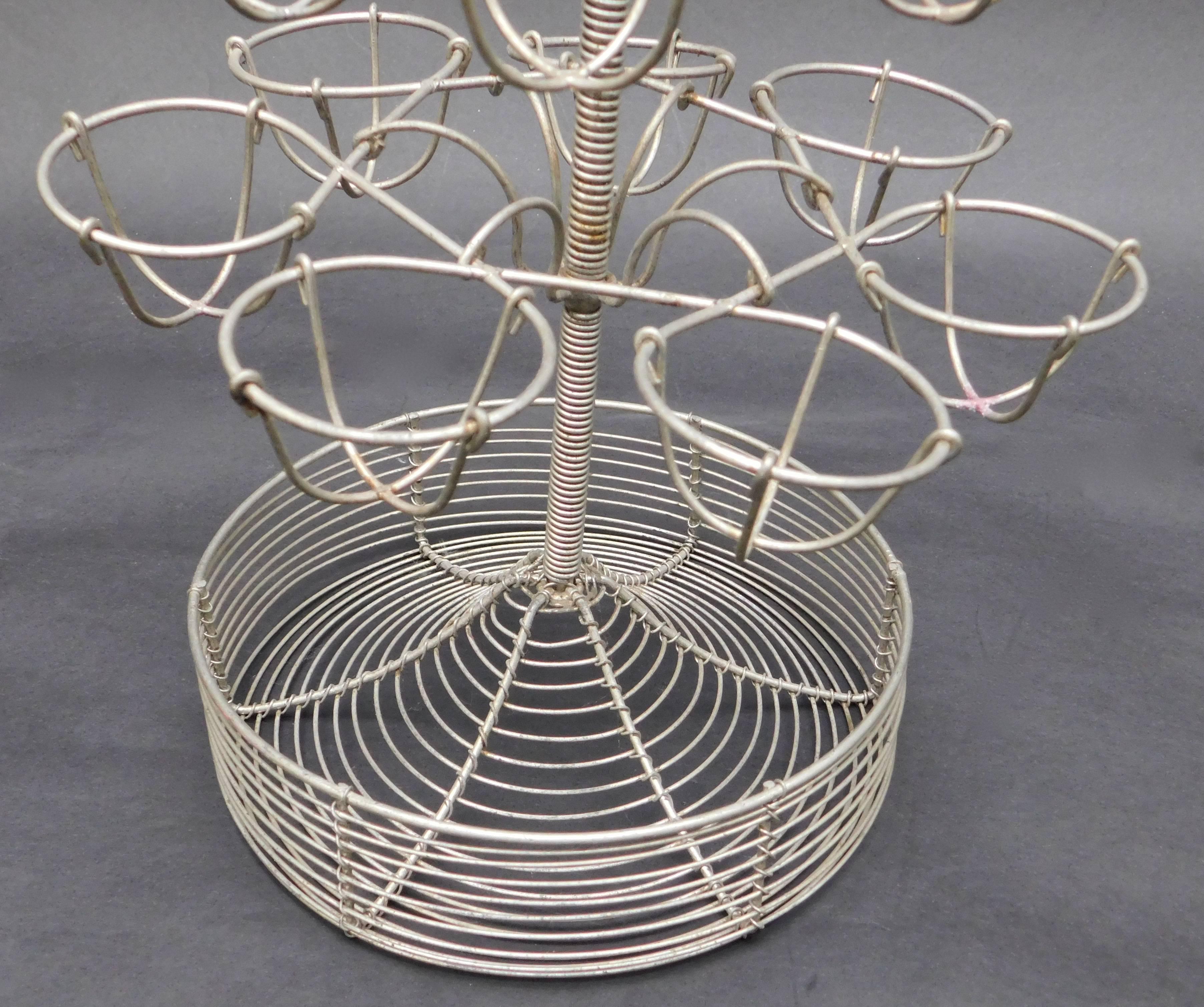 A French egg stand used in French bars to hold boiled eggs.
Hard boiled eggs with salt is a typical bar snack in local bars.
This is a nice early 20th century example that makes an interesting centerpiece with candles, plants or eggs.