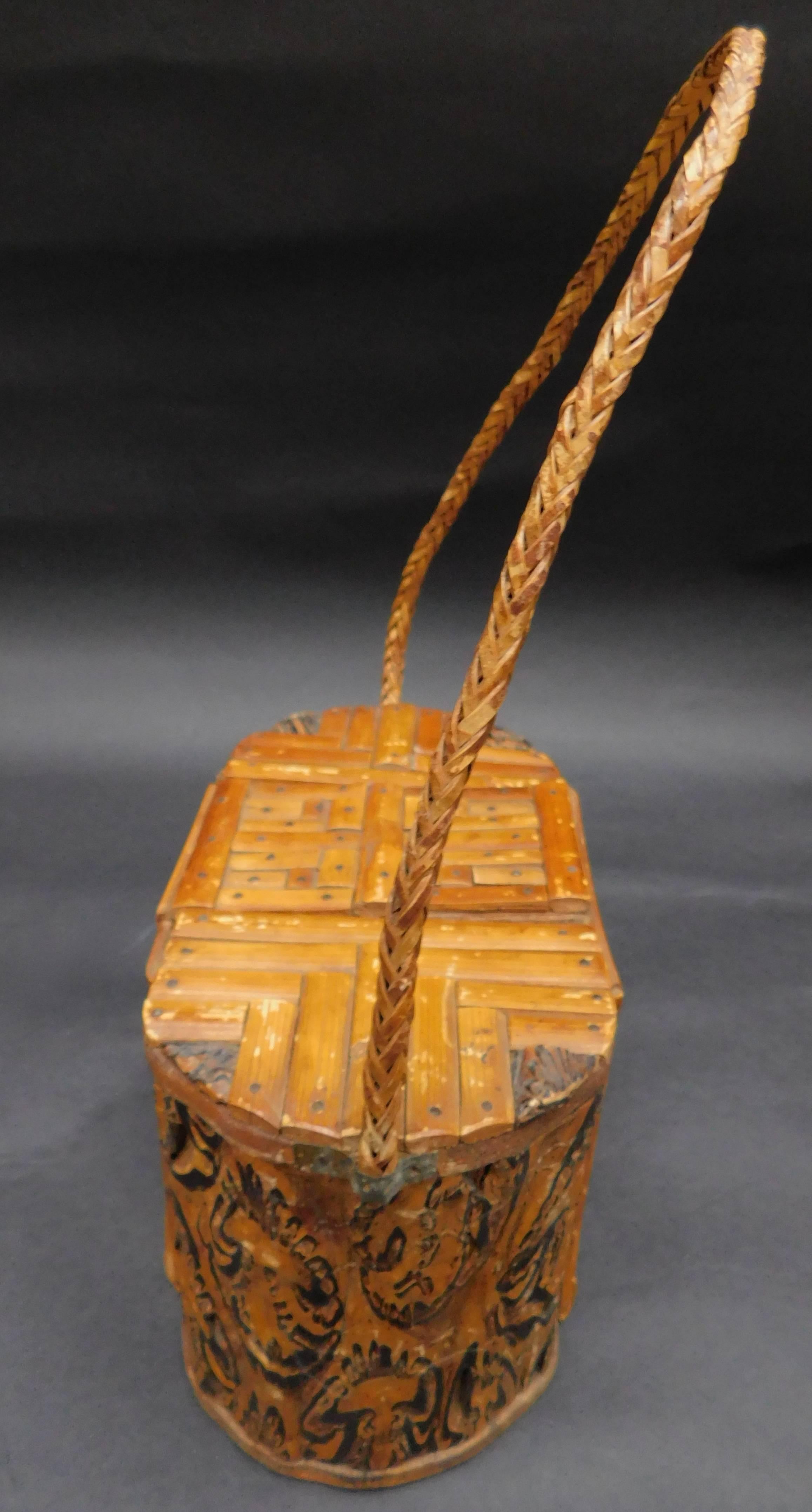 An unusual African wood box with woven rattan handle. The box is hand made piecing together wood to form a curved body. The front, back and top are constructed with bamboo to form maze like square shapes and a hidden lift up lid.
Height with handle