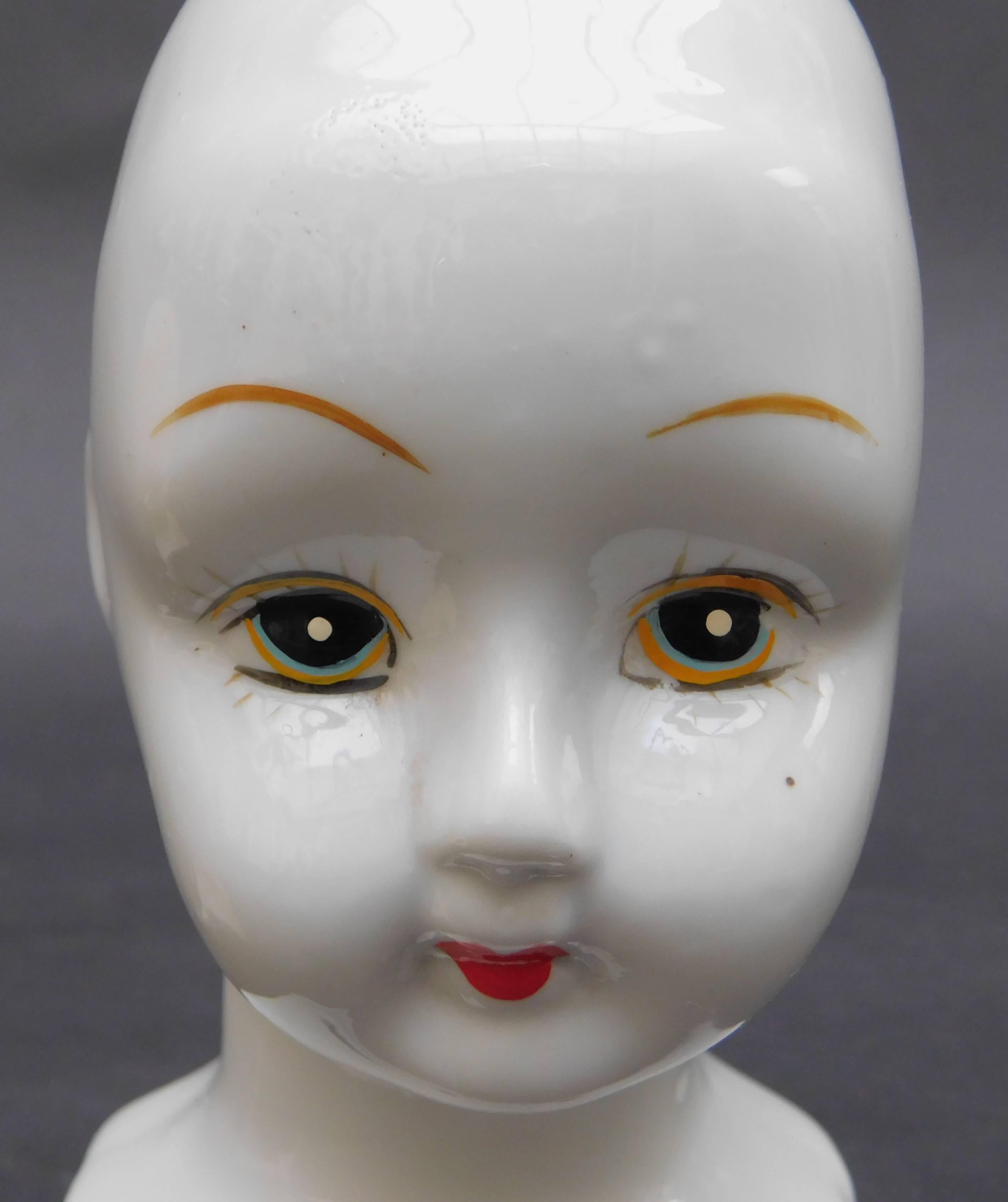 A very interesting sculptural 19th century, German porcelain doll head. I like to see these decorative heads displayed as sculpture curiosities on a bookshelf.