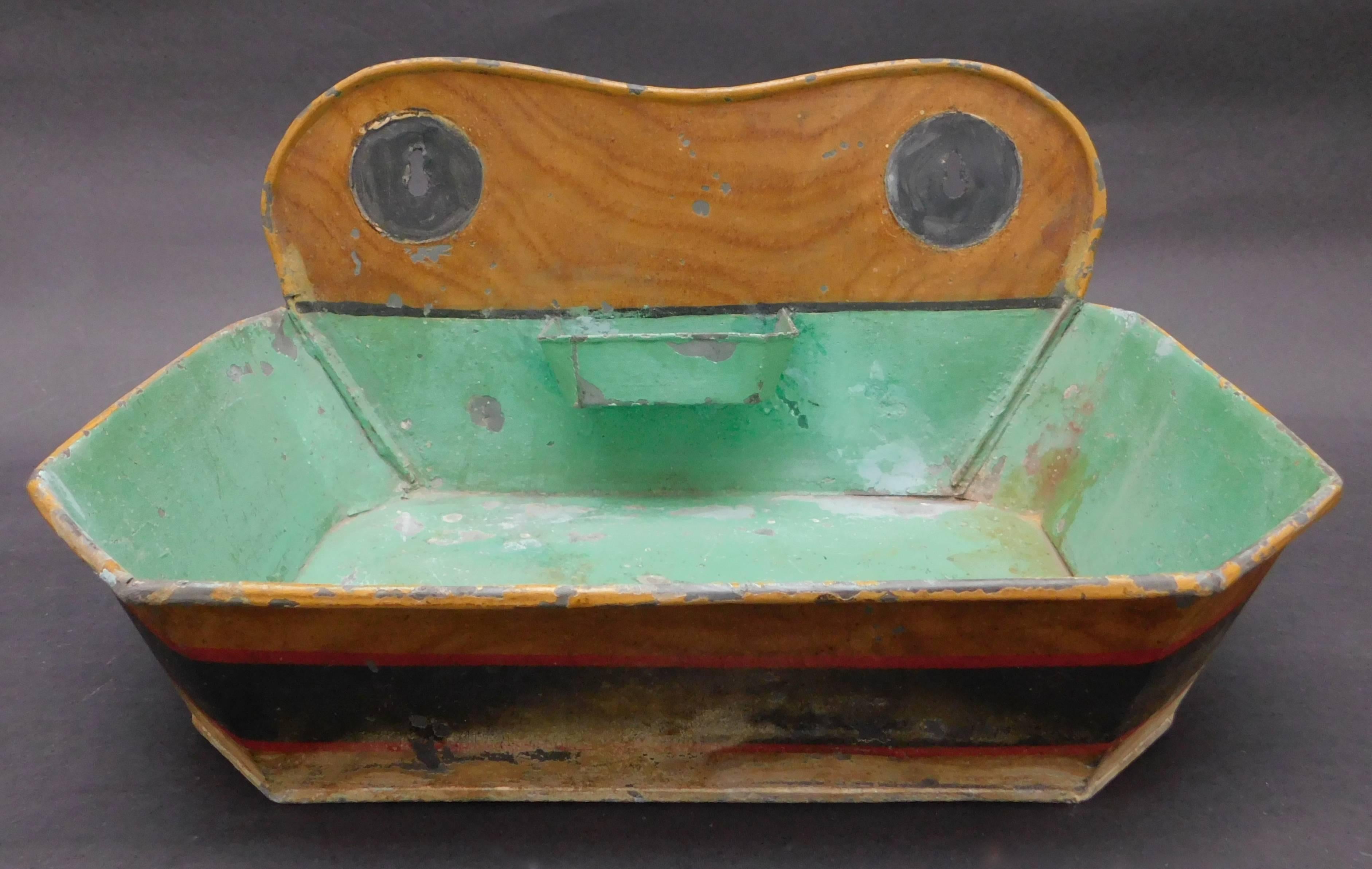 Painted tin (tole) sink retaining the original paint and soap bar holder. This would be an eye catching piece hung on the wall and filled with plants. Belgian, circa 1860.
