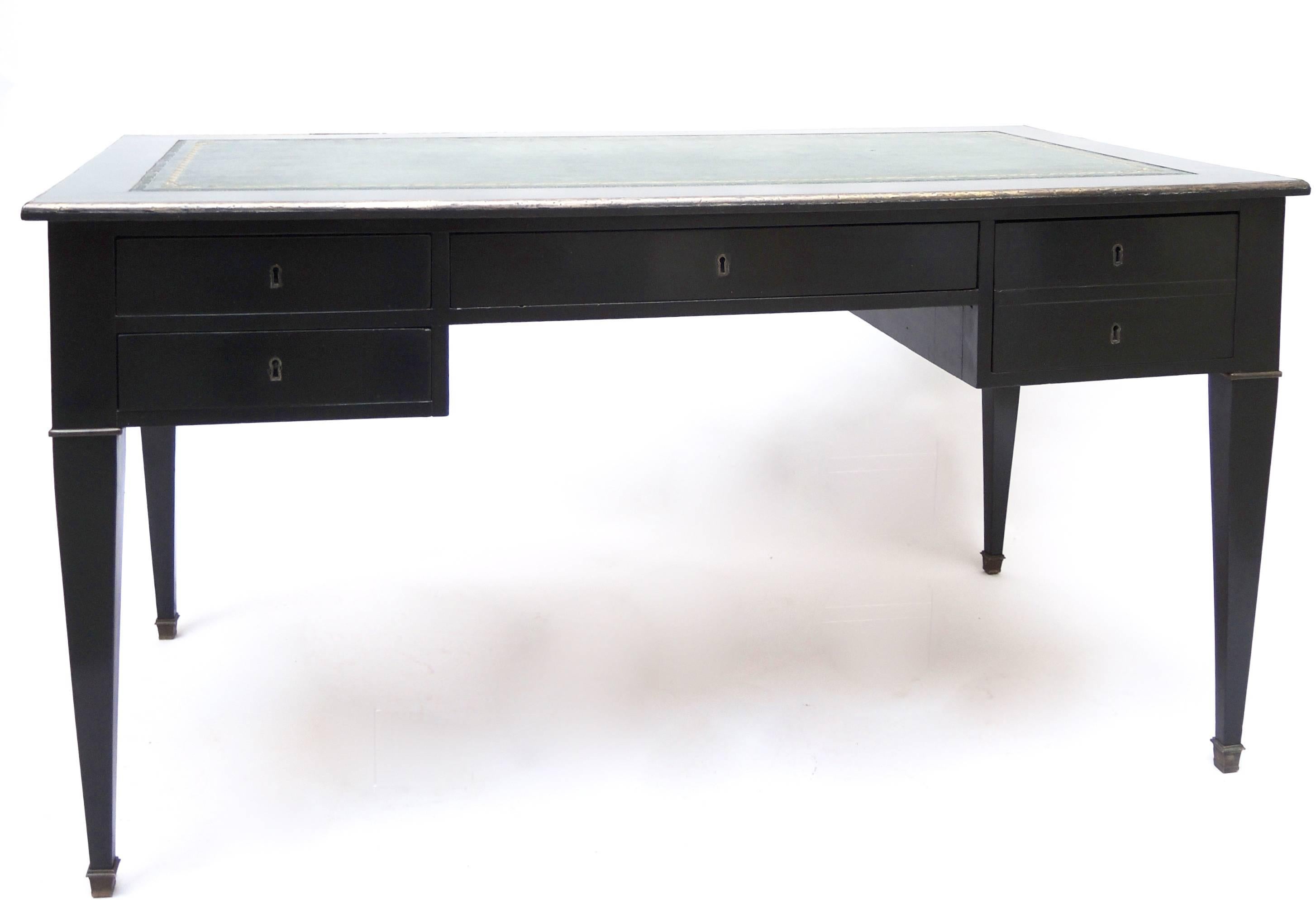 Black ebonized French Empire desk with green leather writing surface .There are additional pull-out writing surfaces on each side, both with matching green leather inset surfaces. Brass edging and foot caps.
 