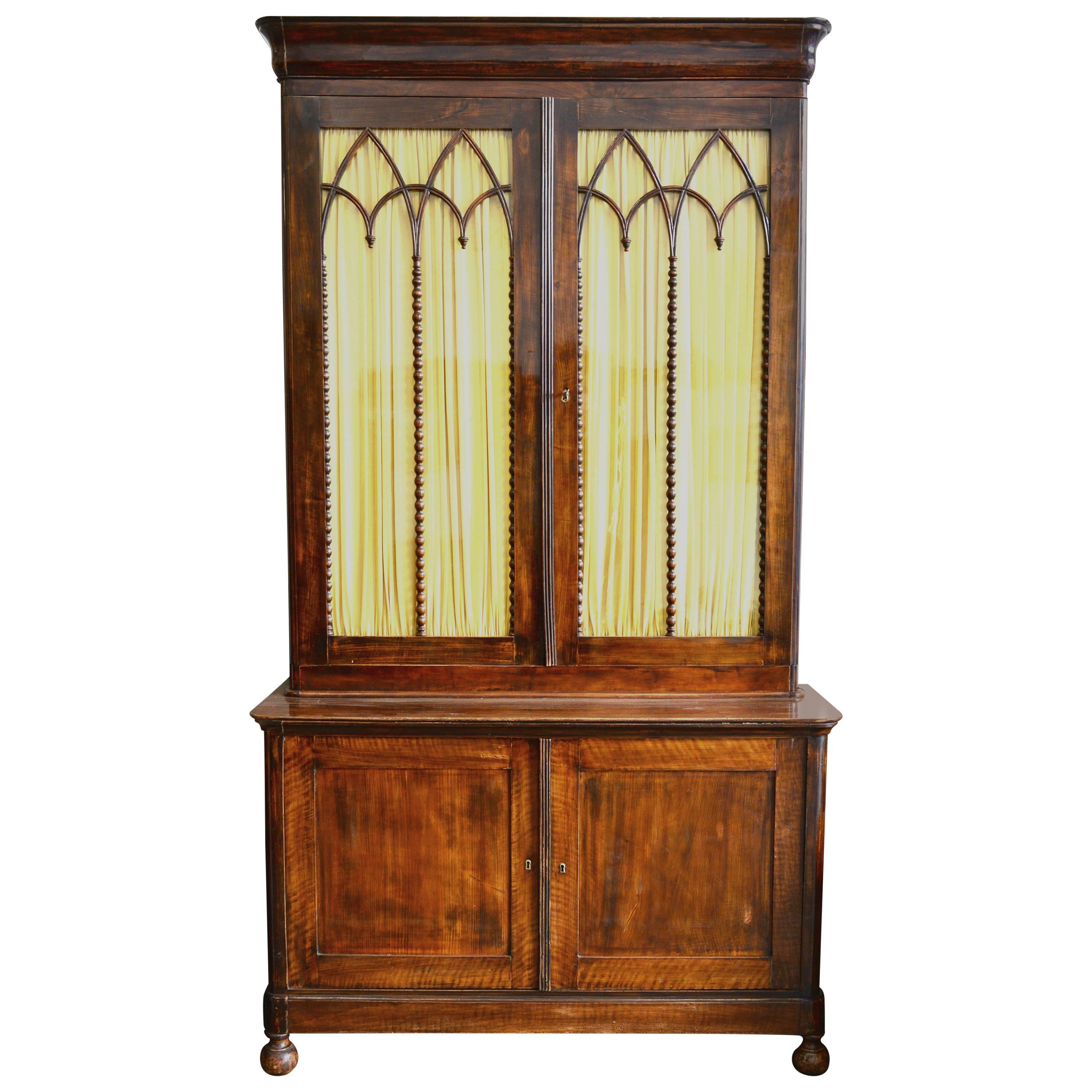 French mahogany Louis Philippe step back bookcase with four doors, circa 1850.
The top section retains the original glass and three(adjustable) shelves 
The interior of both the top and bottom are fitted with shelves and the original step system