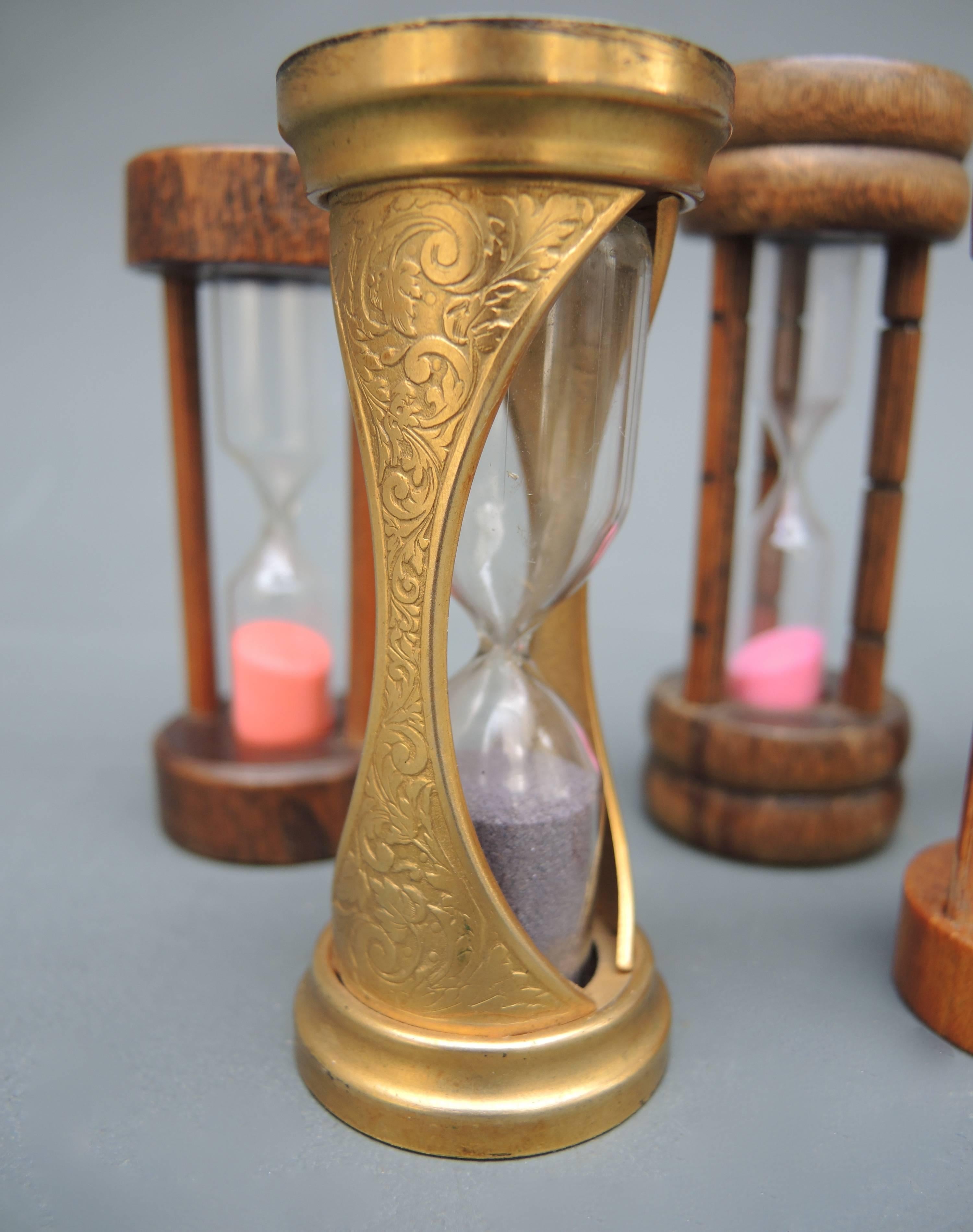 A collection of five sand timers in glass and wood; brass, oak, birch and fruitwood. The sand in each is a different color making for an attractive collection for a desk, bookshelf or kitchen
Measuring: 8.50-10 cm high.