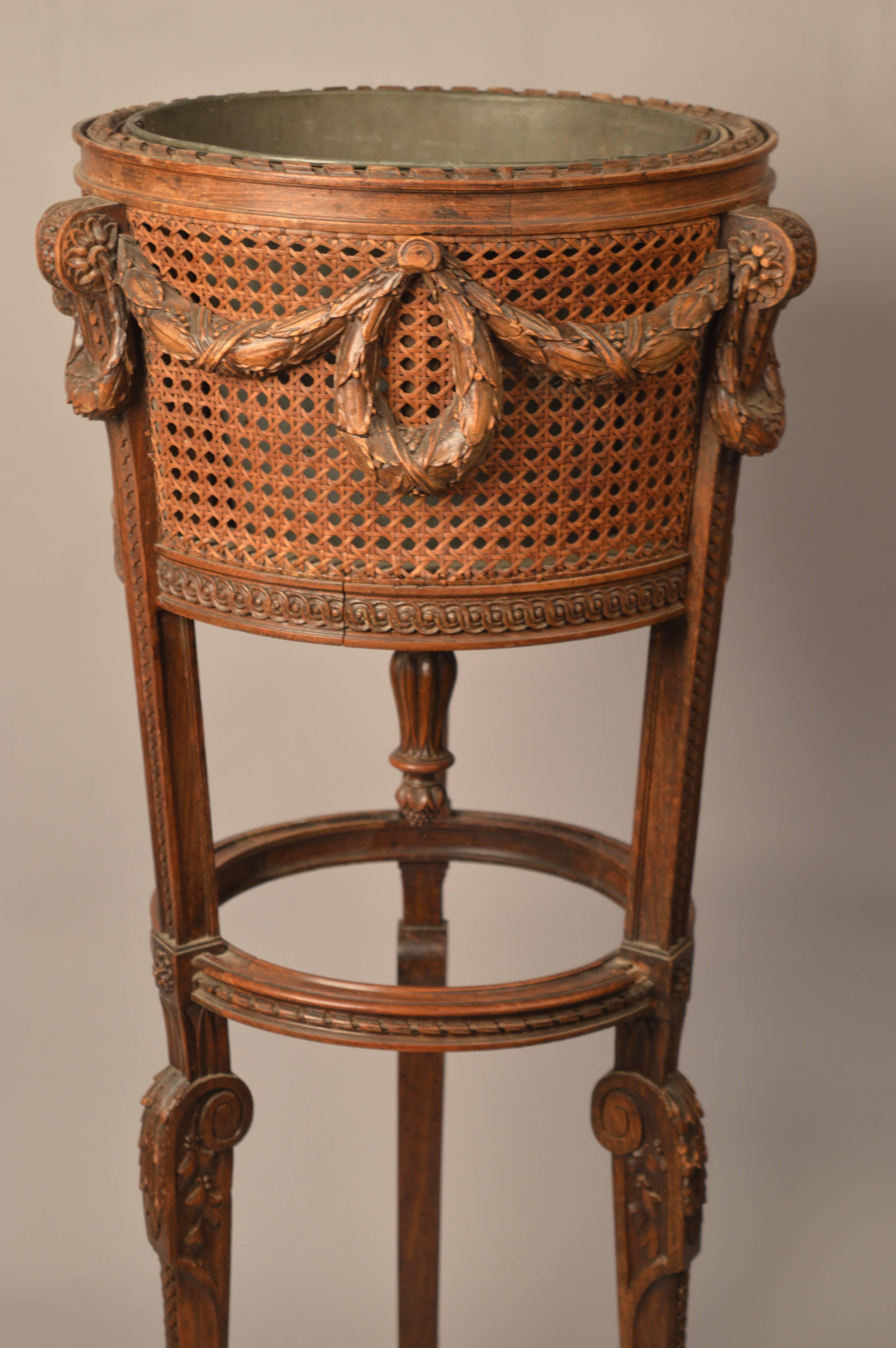 Louis XVI style cane paneled plant Stand retaining the original tole planter insert.
Very fine carved details all in wood.
The last photo is shown as an example of an alternative way to use a standing planter.