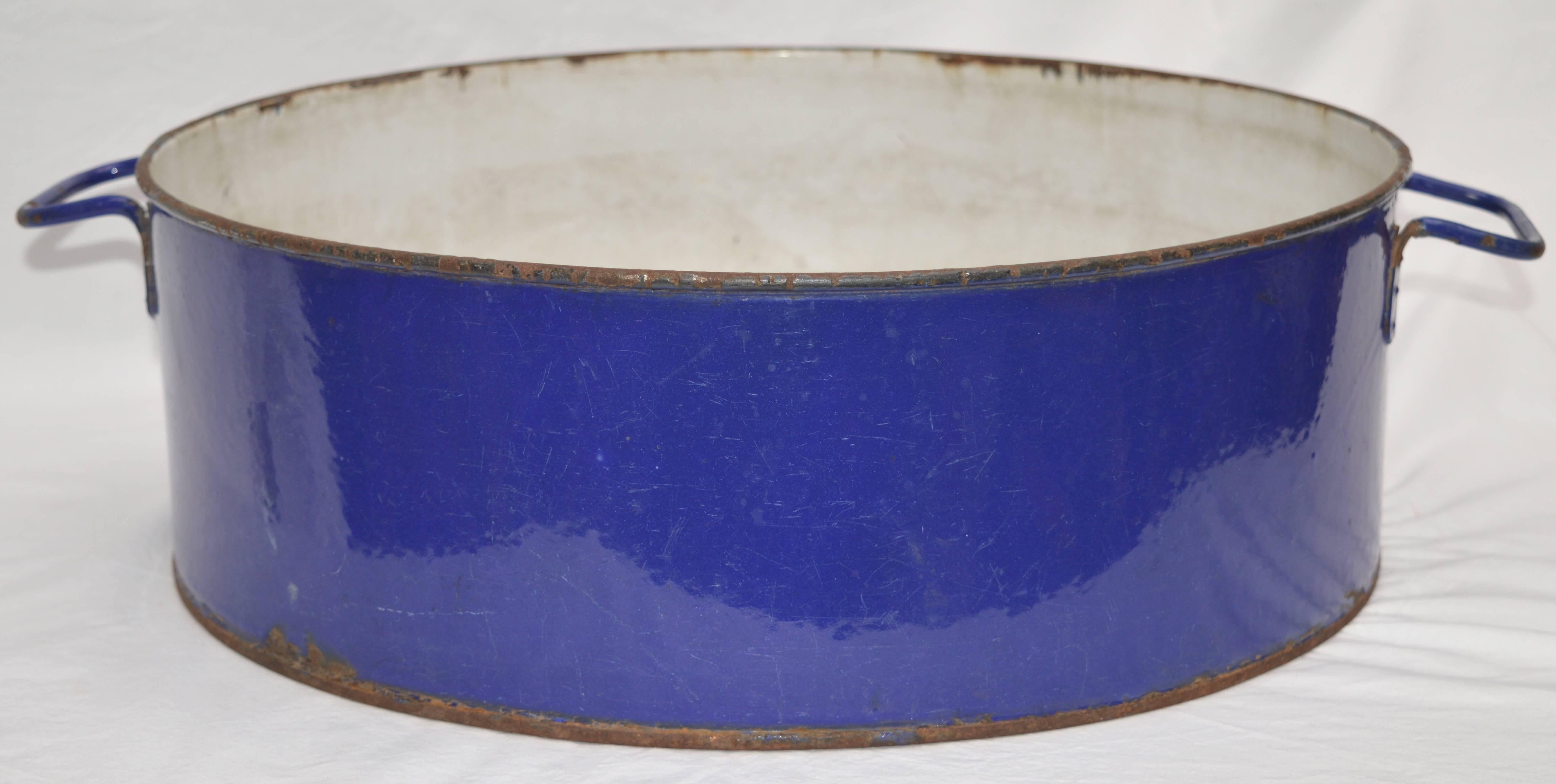 This is a two handled Hungarian vessel used on farms for gathering and washing fruits and vegetables. Great royal blue enamel color makes this a cool center piece or a place to put magazines or bath towels
 The last photo is an example how this