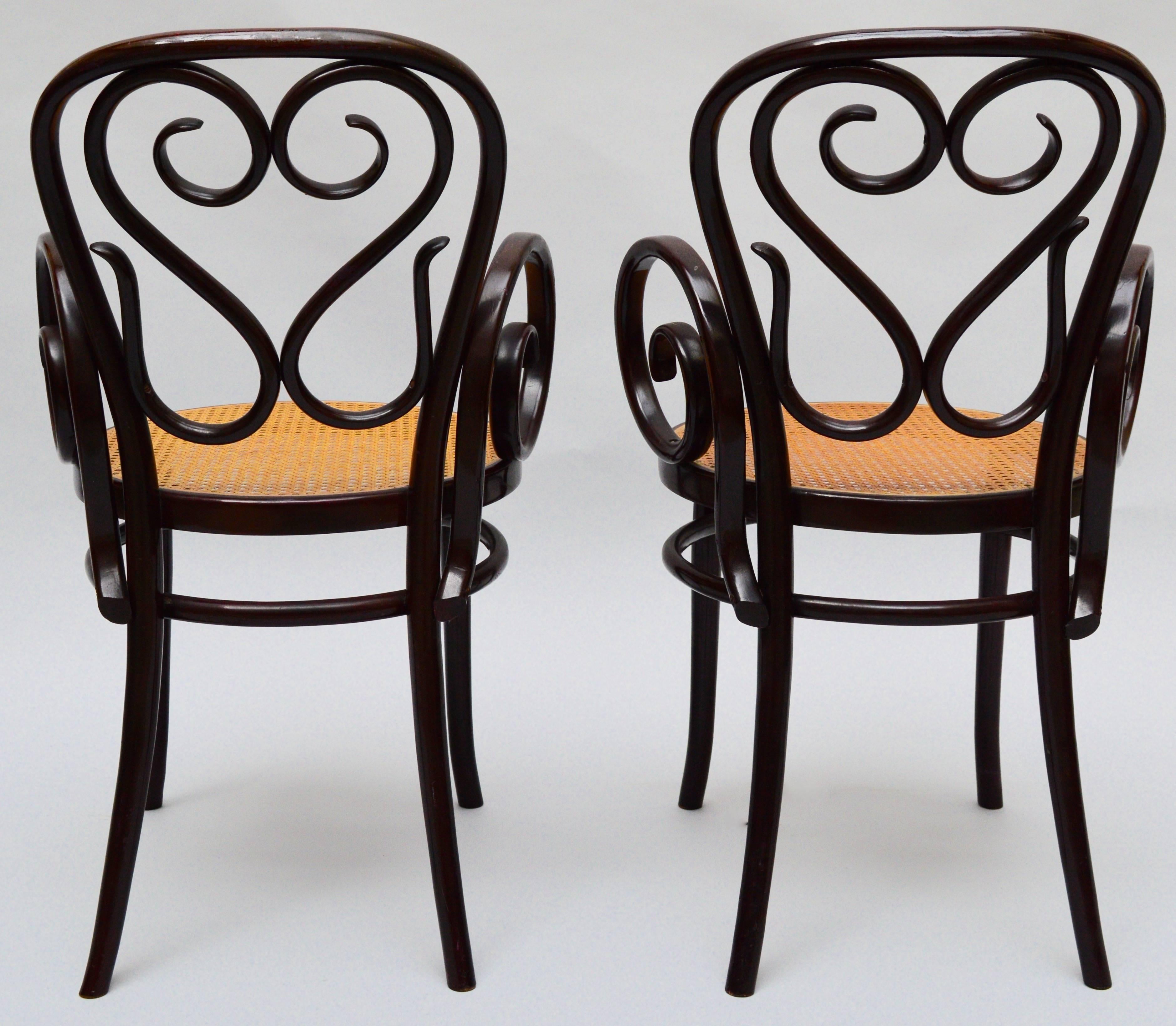 A pair of bentwood armchairs with caned seats, excellent condition.
The chairs are unmarked other than the worn 