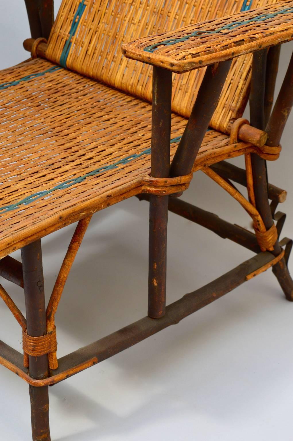 A Vintage Circa 1920 French woven rattan lounge chair with detachable footrest and adjustable back. The frame is made from twigs with smooth bark which lends special one of a kind character only found in a handmade piece.
The ultimate in chic lounge