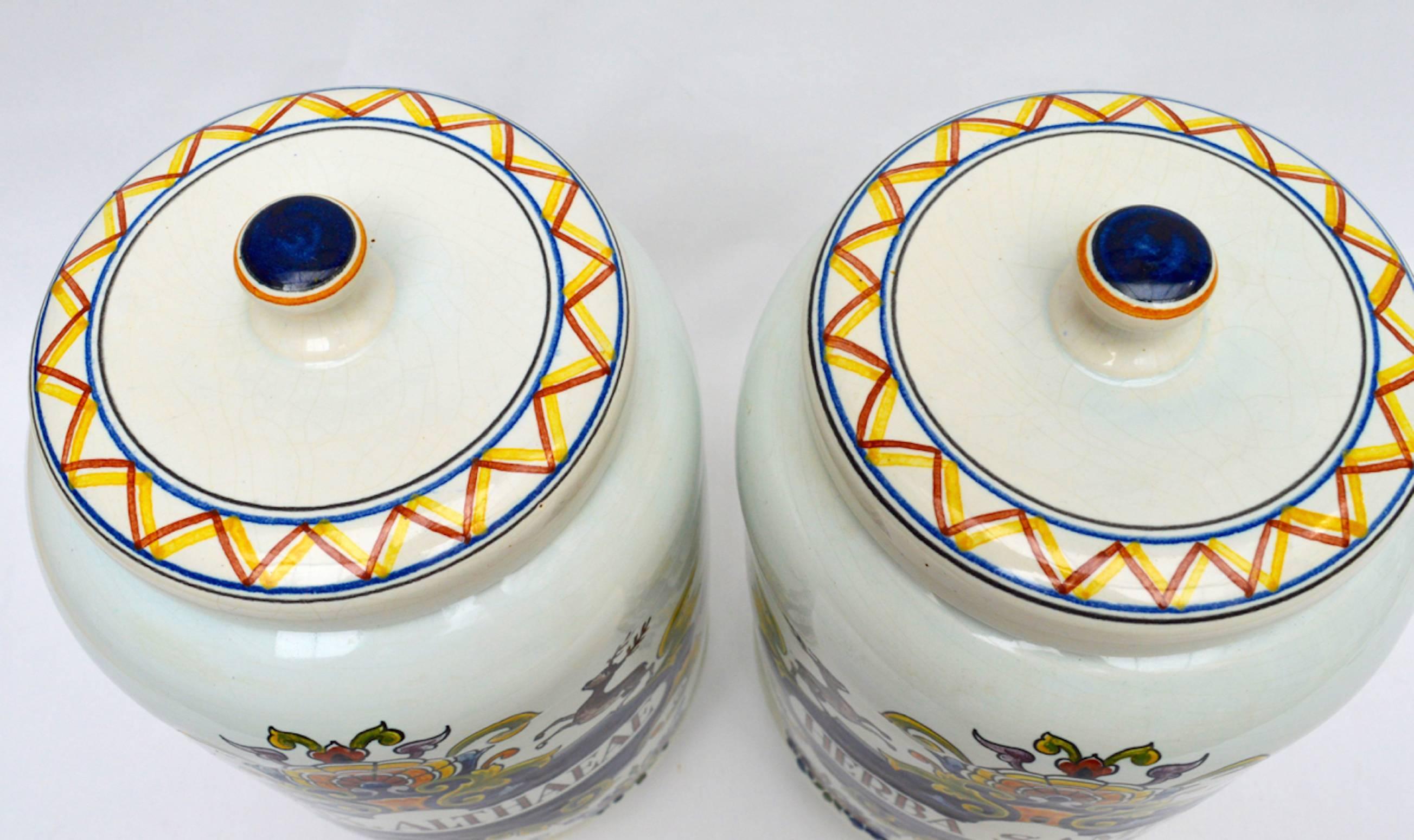 A pair of faience glazed ceramic apothecary jars made by Oud Delft in Nijmegen, Holland. In excellent condition.