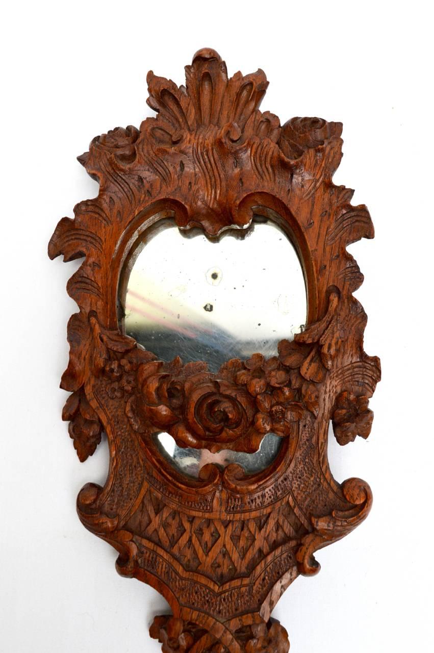 A detailed hand-carved French 19th century hand mirror retaining the original mercury glass and in excellent condition.
