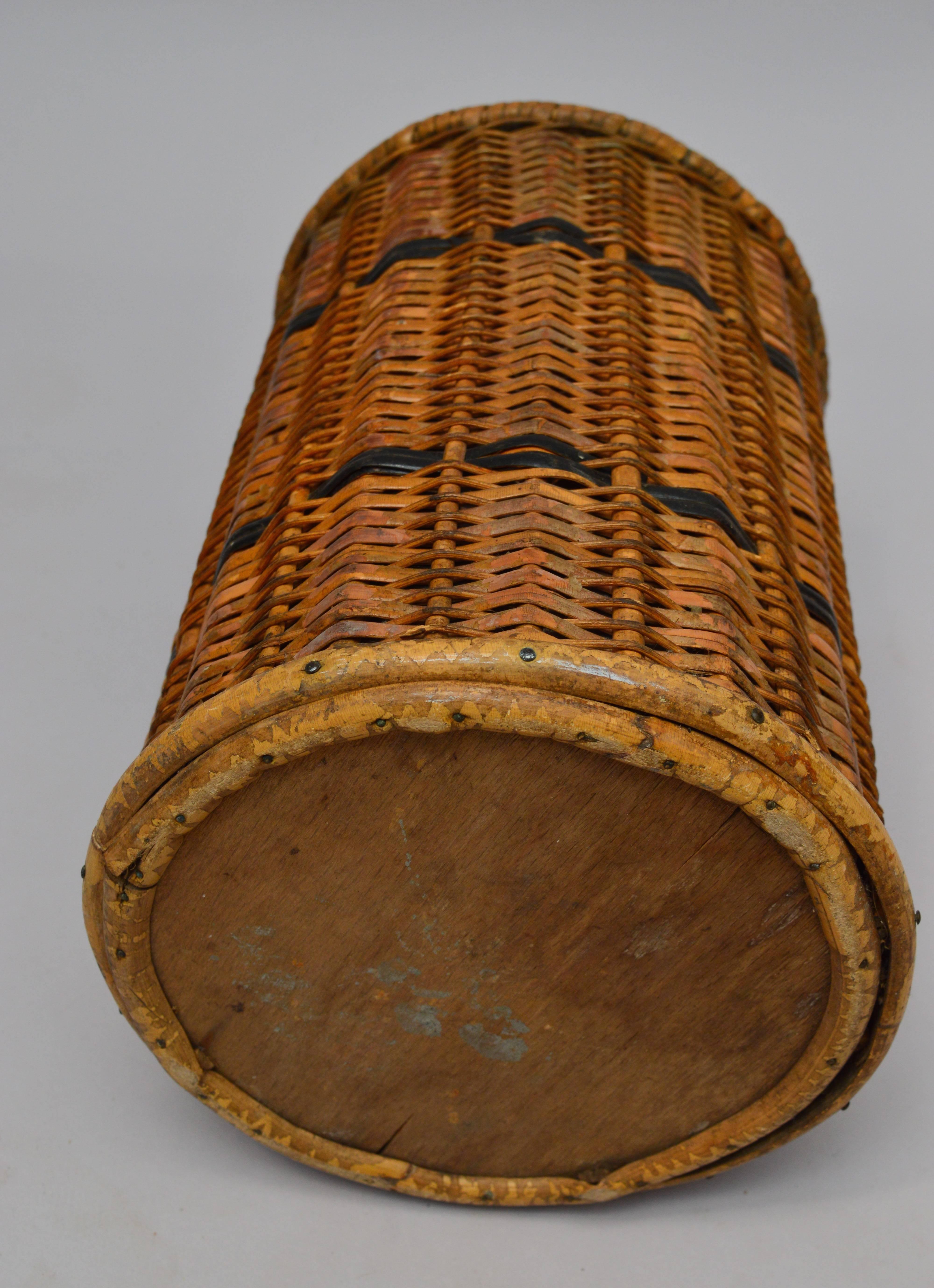 French woven rattan trash can lined with tin. Nice small size for under a desk, but could also be used as a vase or wine cooler!
 