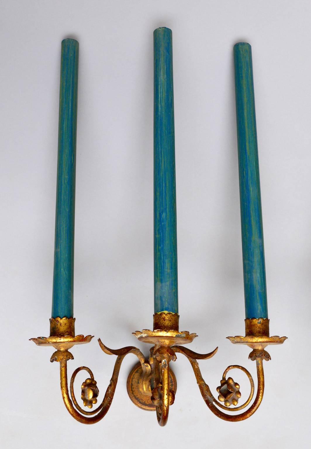 Pair of 1930s Italian gold leafed tole and hand-wrought iron sconces.
Elongated paper and wax faux candles disguise the electric sockets.
In very good condition and ready to install.
