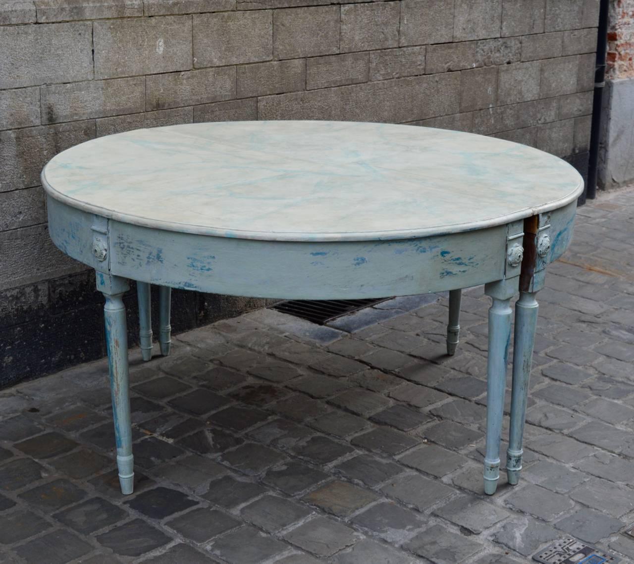 A large pair of demilune tables with faux marble painted tops. Several layers of paint including white, grey, green and blue give this otherwise formal design a more soft relaxed feeling for which Swedish furniture is known and loved.