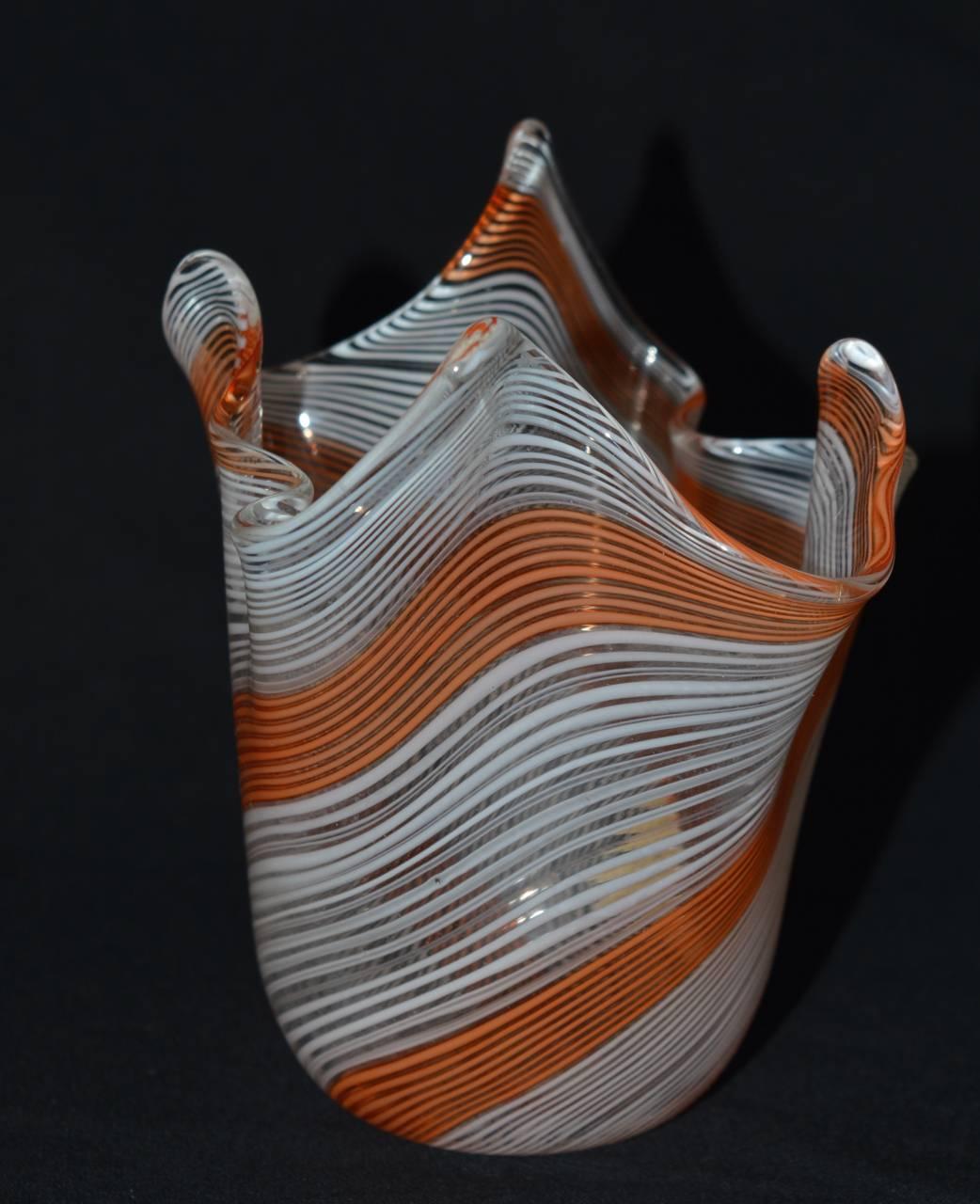 A 1950s handblown Murano glass "handkerchief" form vase attributed to Venini. In excellent condition with the original label. Distinctive orange and white striped pattern are artfully swirled in the twisting of the molten glass.