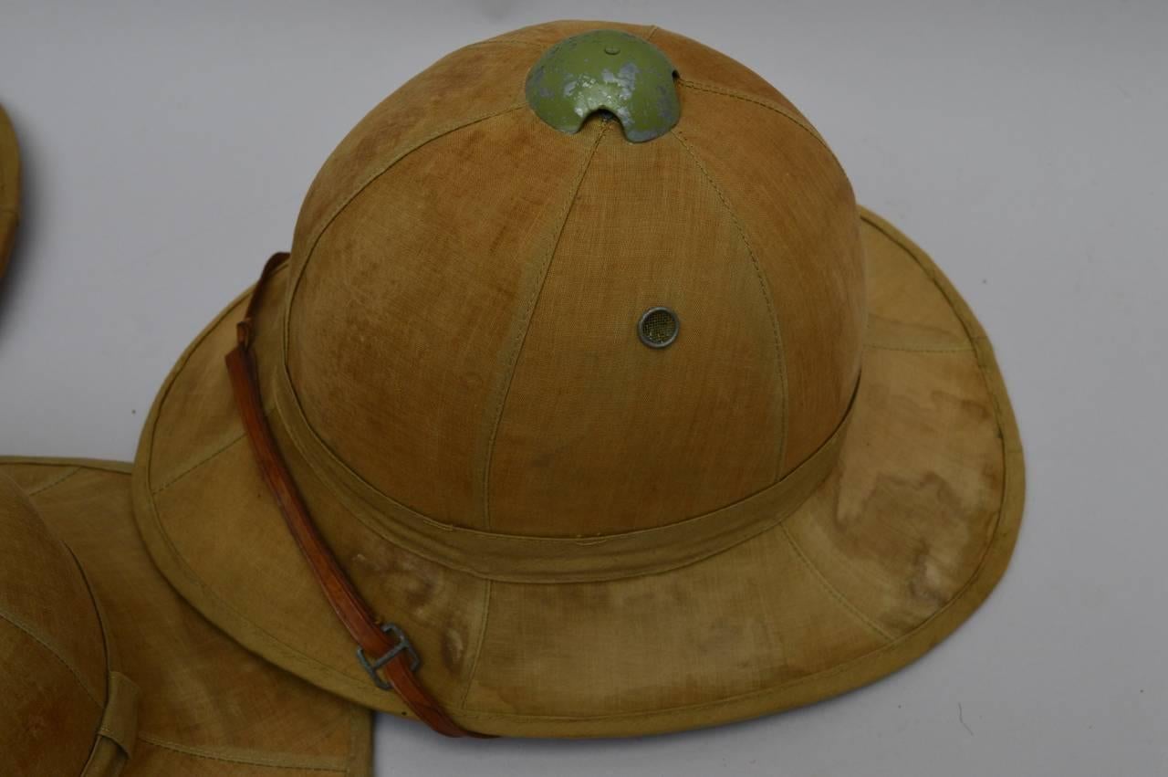 These two Wolseley model pith helmets were used in the Belgian Congo in the 1940s. The Wolseley model was adopted by the Belgian troops from WWI until 1960 when Belgium left the Congo. Made of thin cork, the hats were soaked in water to provide