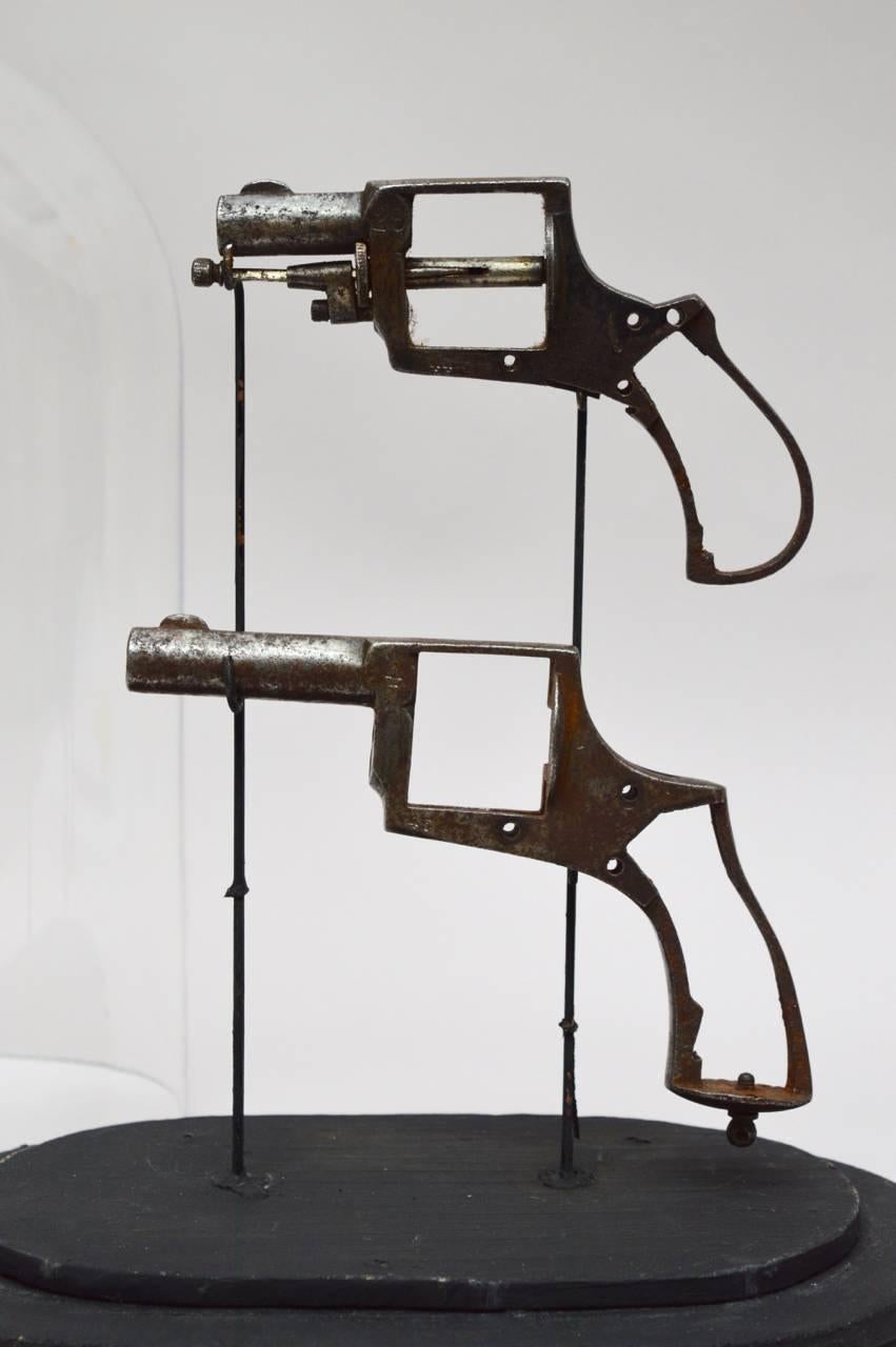 Vintage Hand Gun Frames Mounted on Stands and Presented in a Glass Dome In Good Condition In Antwerp, BE