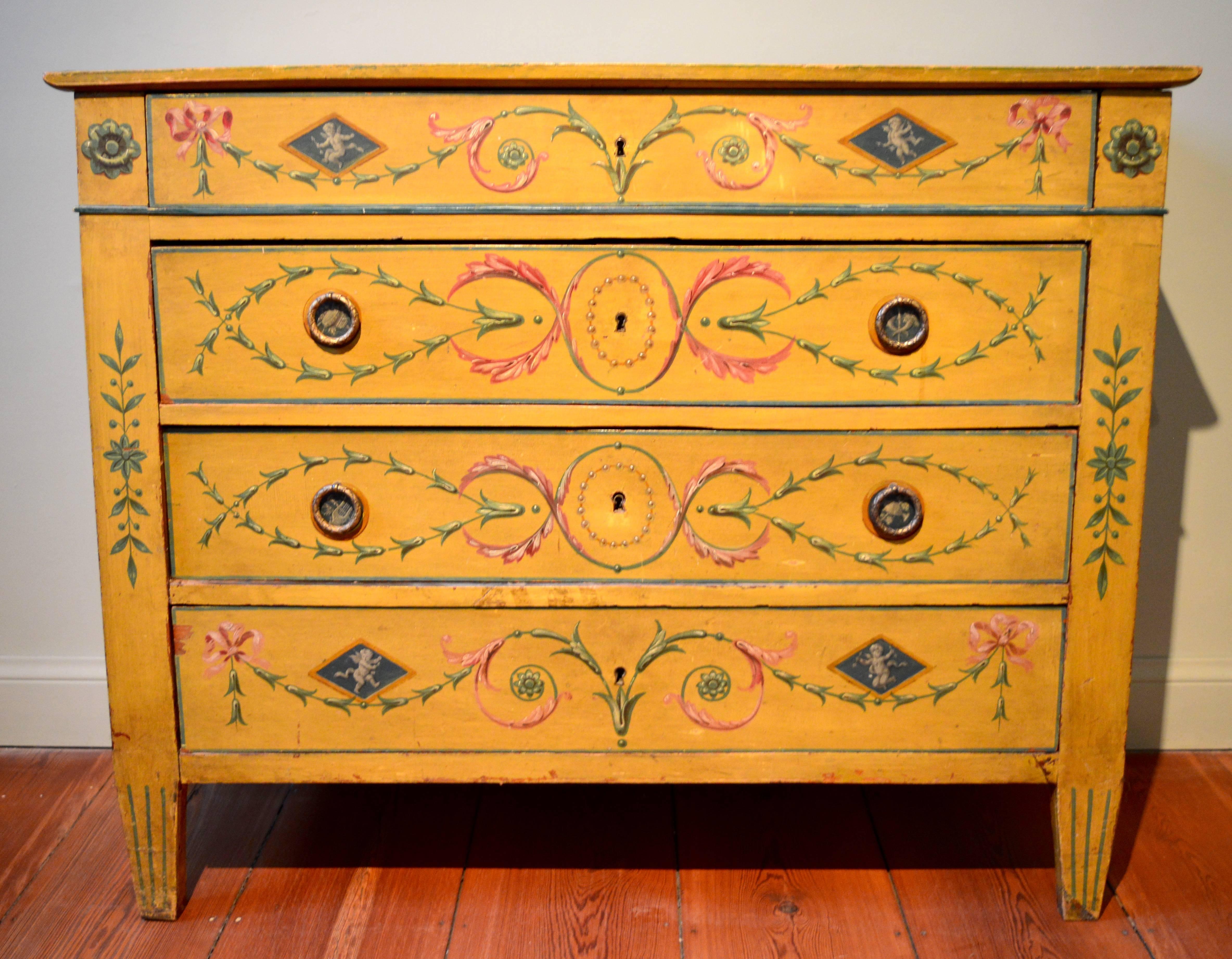 An early 19th century Empire yellow Austrian painted commode .The classical scenes of goddesses and symbols of the arts are superbly painted as are the trompe l'oeil chains of pearls surrounding the key holes.
  