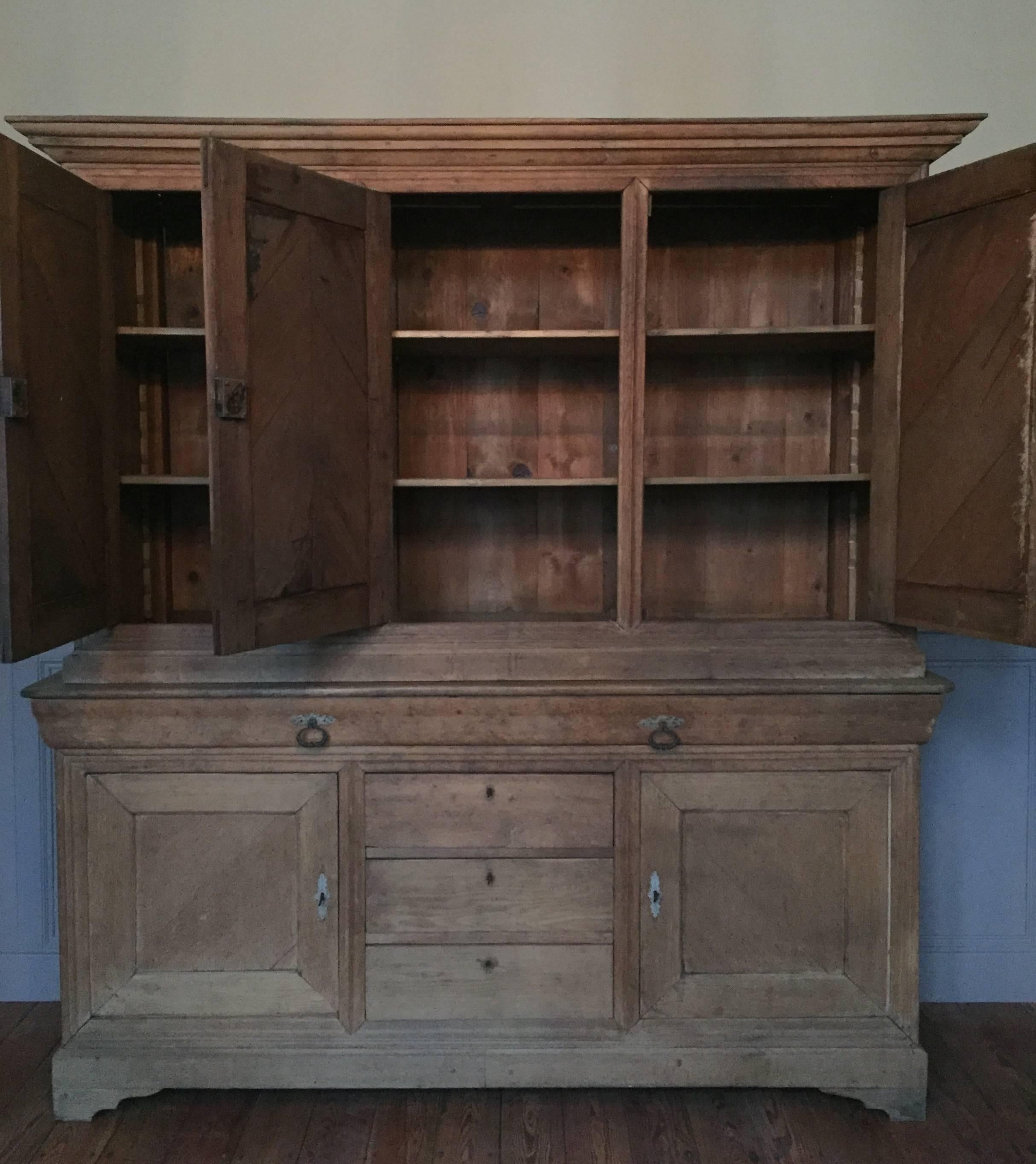 French Louis Philippe period "Deux corps" cabinet made in solid bleached oak. The doors have an elegant chevron pattern achieved with solid oak panels set into the door frames at an angle. The center drawer is extremely unusual in that it