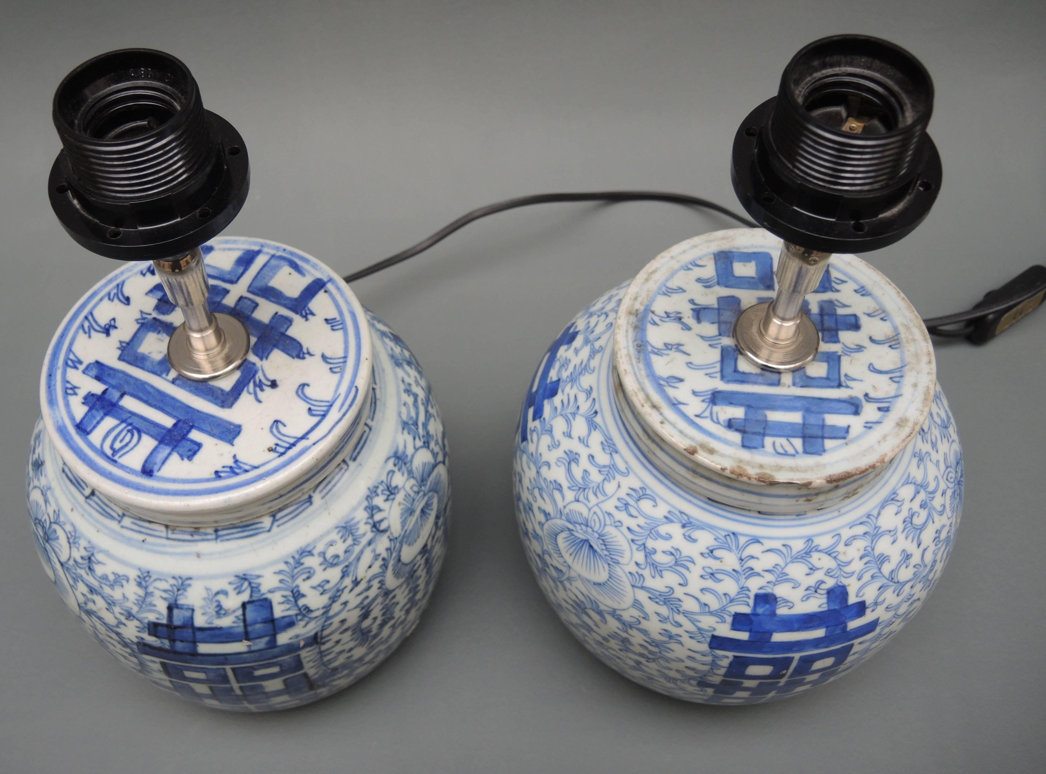 A pair of antique circa 1900 blue and white Chinese ginger jars that have been made into lamps.