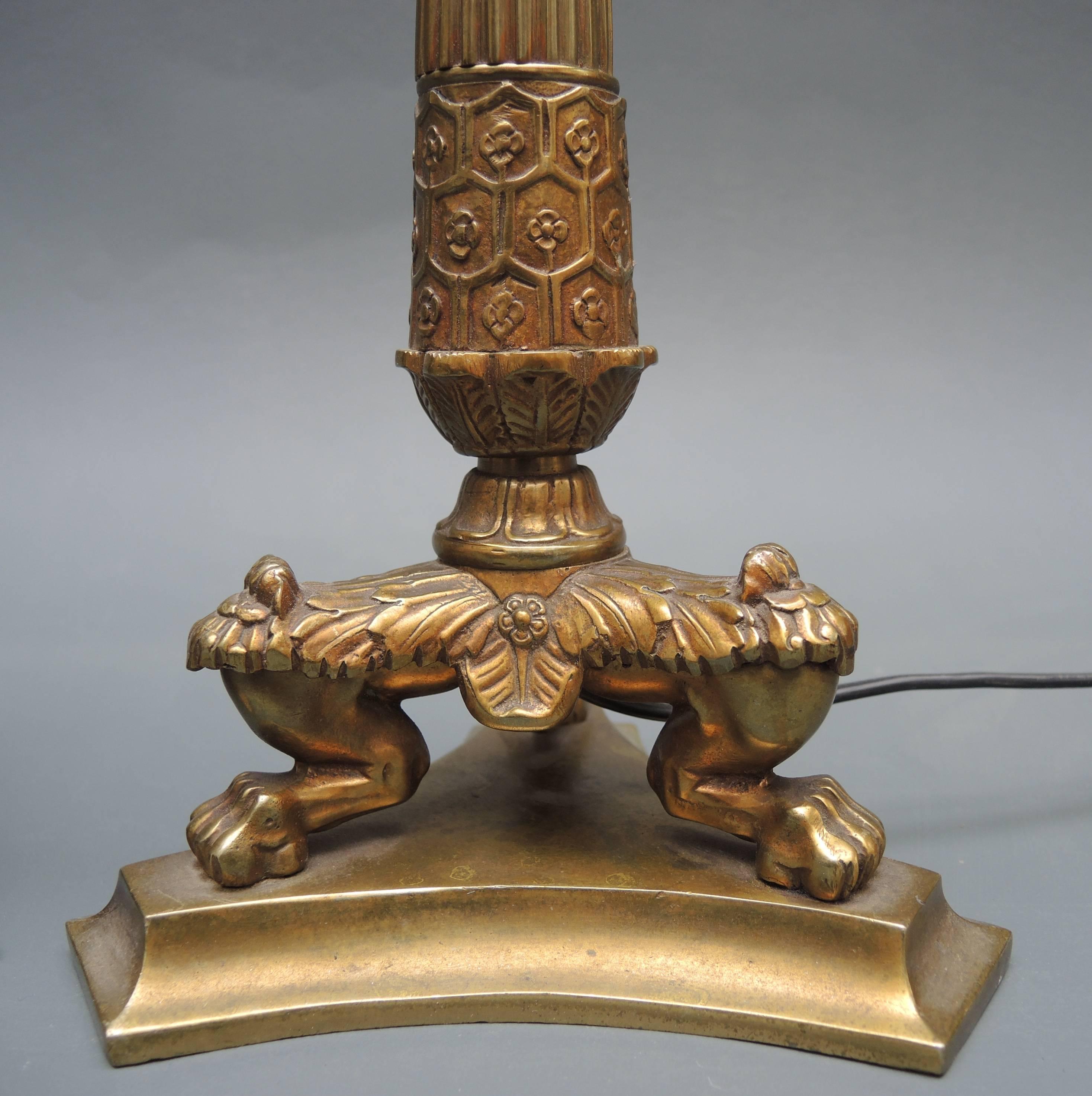 A pair of solid cast bronze French Empire style candlestick lamps circa 1960. The fine detailed casting gives these lamps an elegant but strong impression on a desk or console table, (especially when simple black shades are used.)
