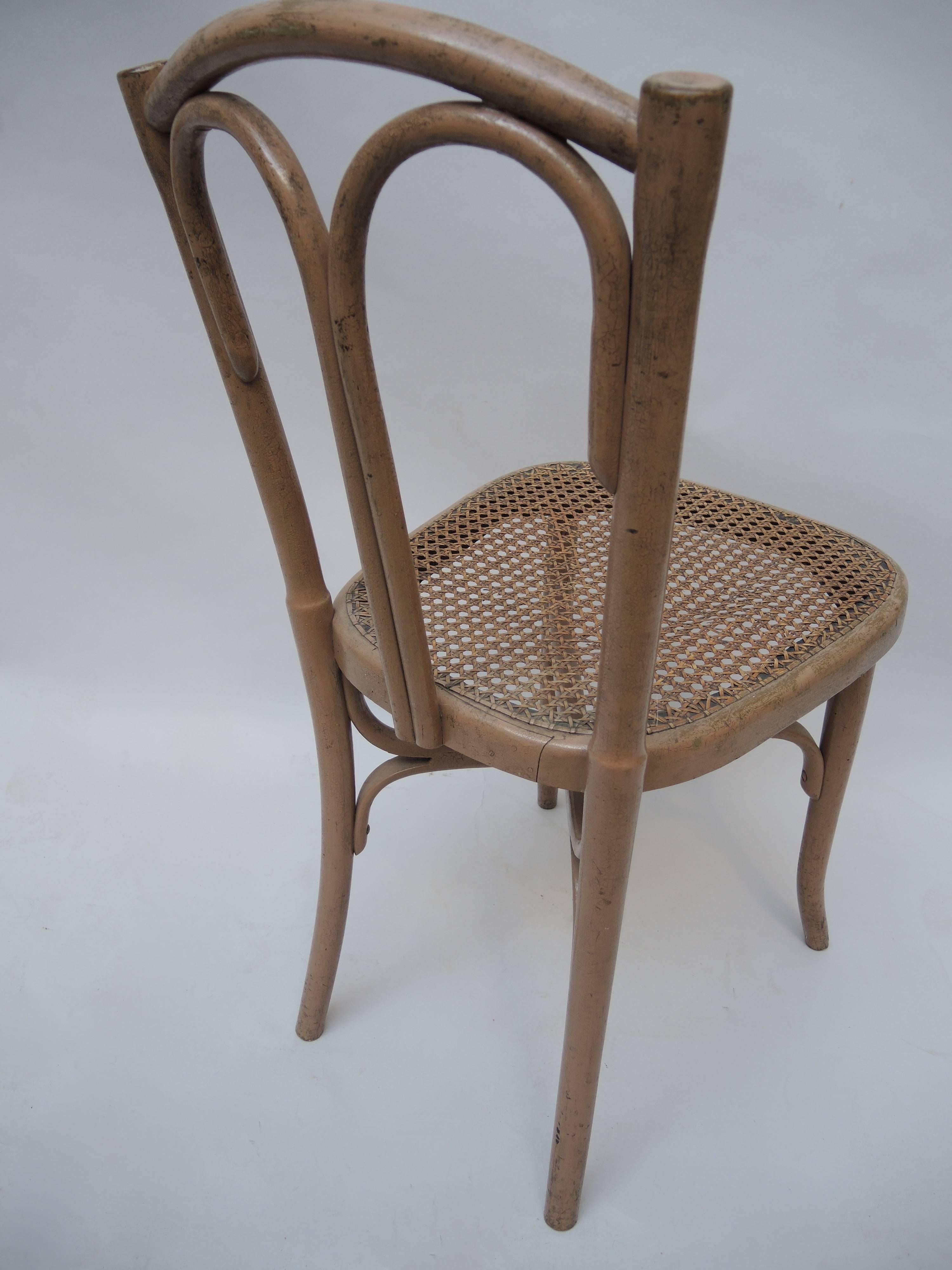 A Belgian bentwood cafe chair retaining the original paint and cane seat. Made by Cambier Freres (Ath, BELGIUM)end of the 19th century, 1889. Stamped CAMBIER on the frame.
  