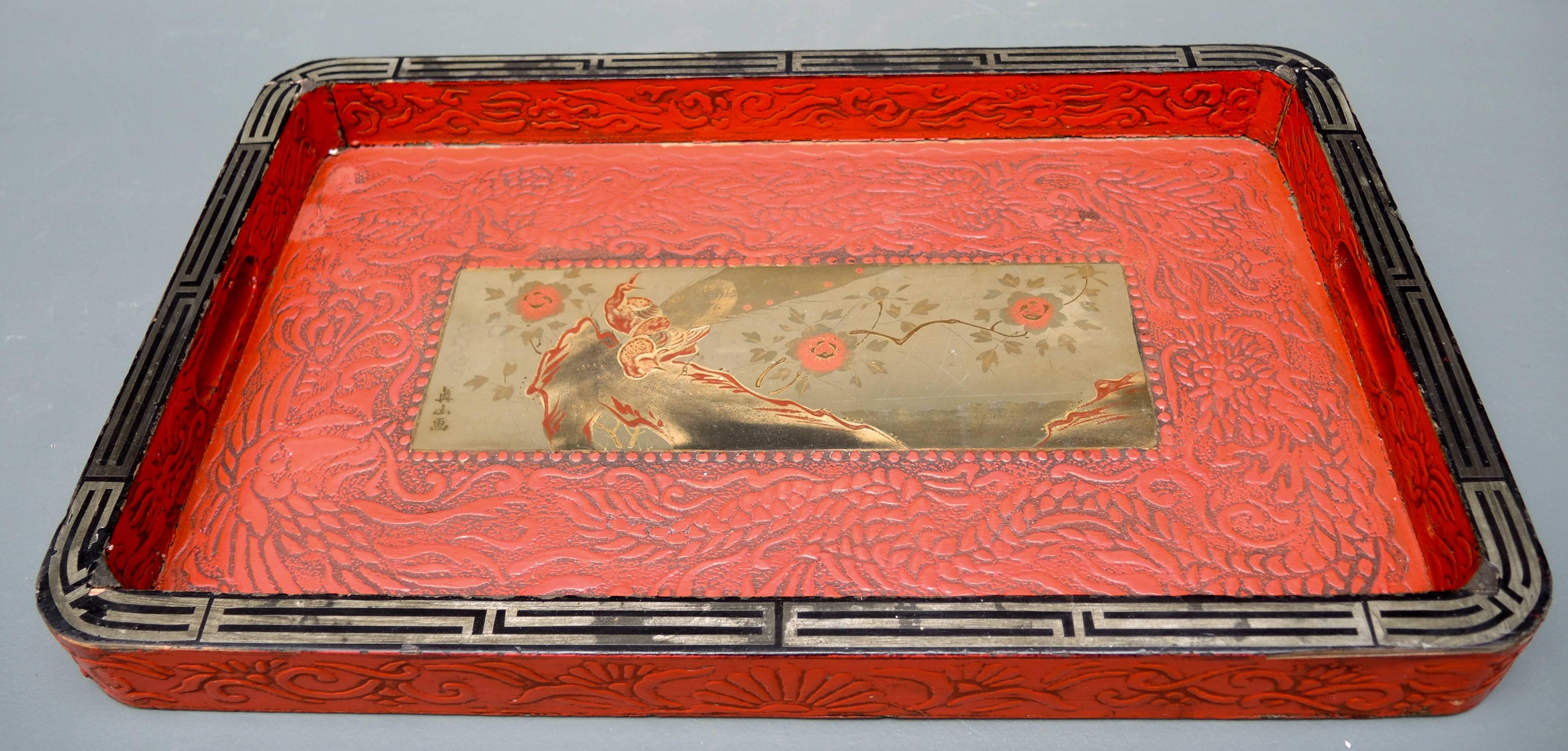 Beautiful Japanese tea tray of carved wood with lacquered surface.
The center has a beautiful painted lacquer-work and gold painted scene of a peacock on a branch. Signed by the artist center left side.