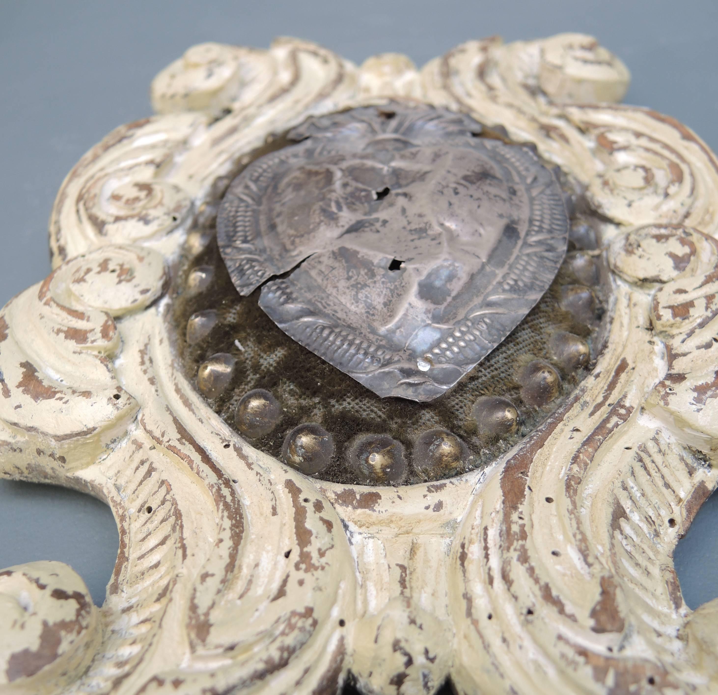 Italian wood devotional plaque with a hammered silver flaming devotional heart set onto velvet background, circa 1820.
