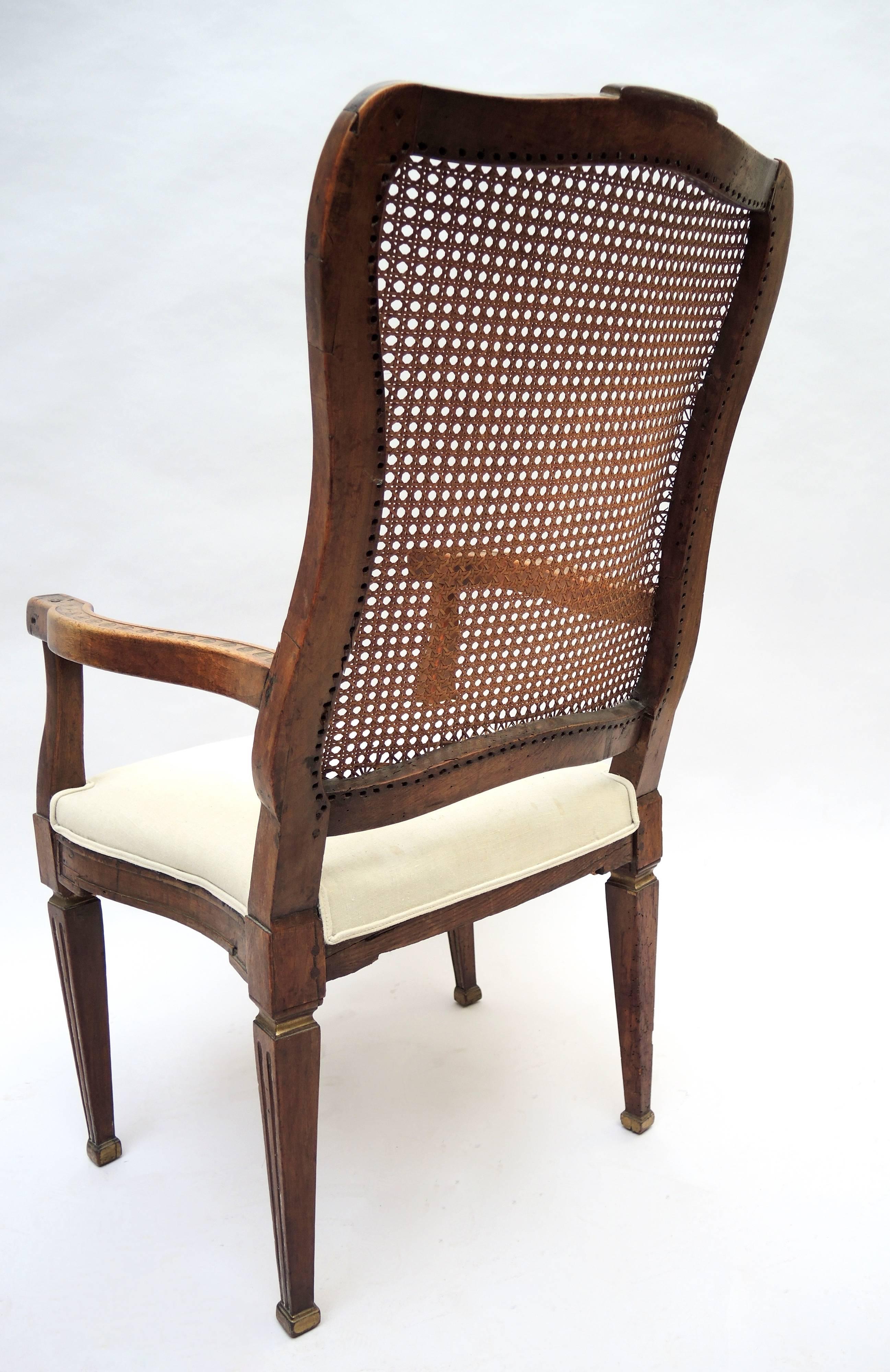 Dutch armchair retaining the original cane woven back, circa 1820. Pegged construction and beautiful patina complete this elegant and unusual armchair.
In very good firm condition with a newly upholstered seat using antique Flemish Linen.
