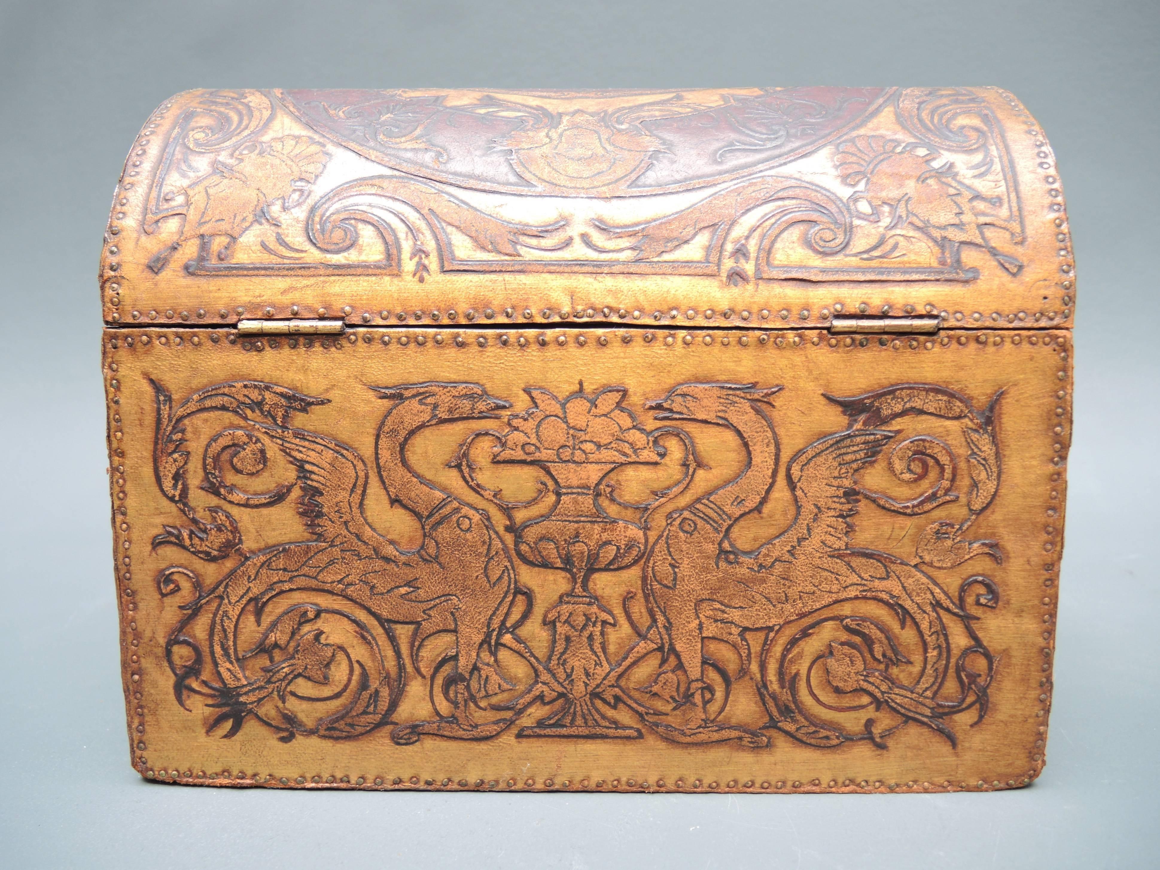 A classical shaped Flemish box covered in embossed gilt and painted leather produced by hand in Mechelen dated 1912. The ornately decorated leather fully embraces the designs and tastes of the Art Nouveau period.