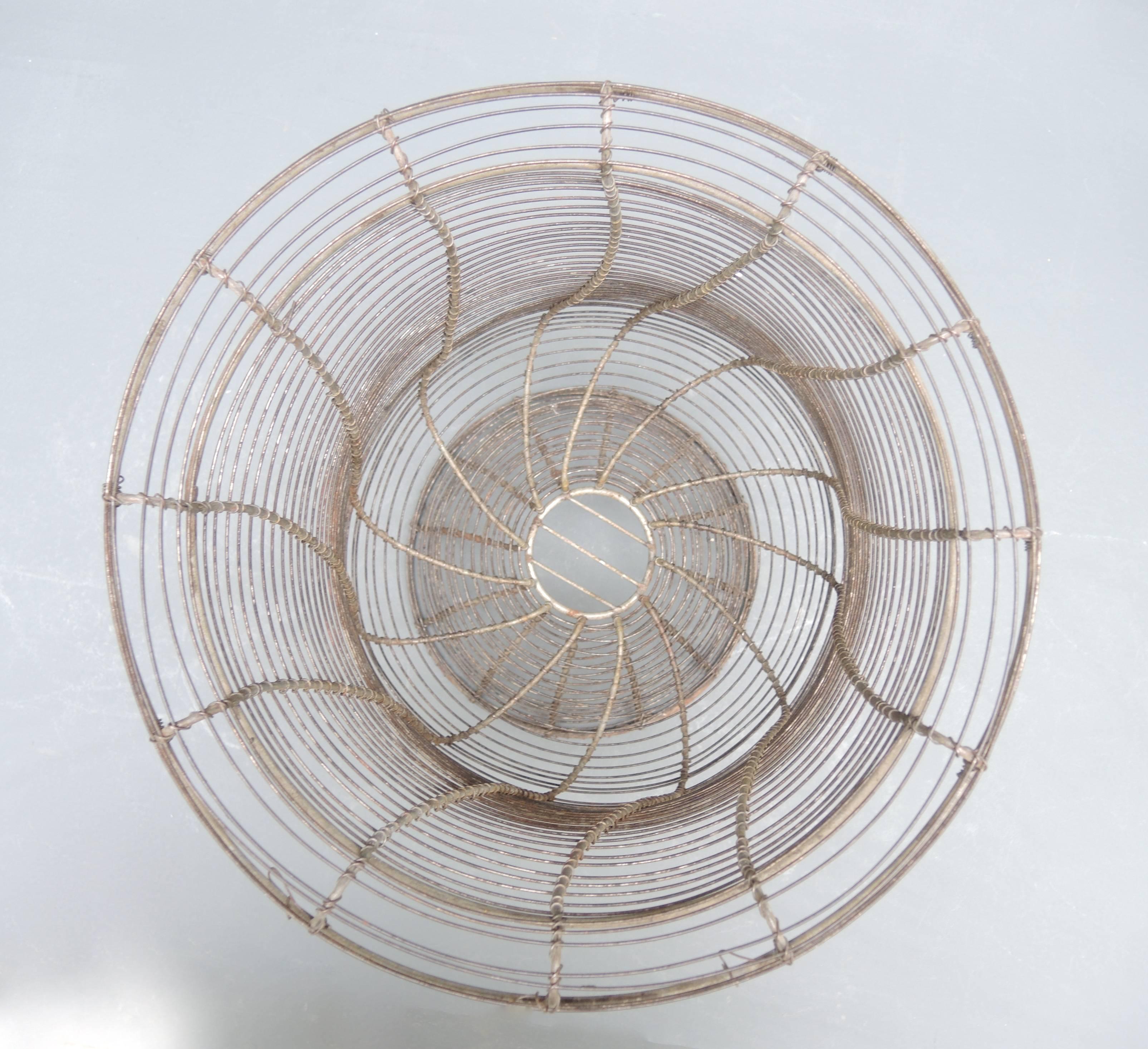 French wire work woven urn basket circa 1920. Wirework urns and bowls were used to store fruit and vegetables to allow air to circulate and prevent rotting.